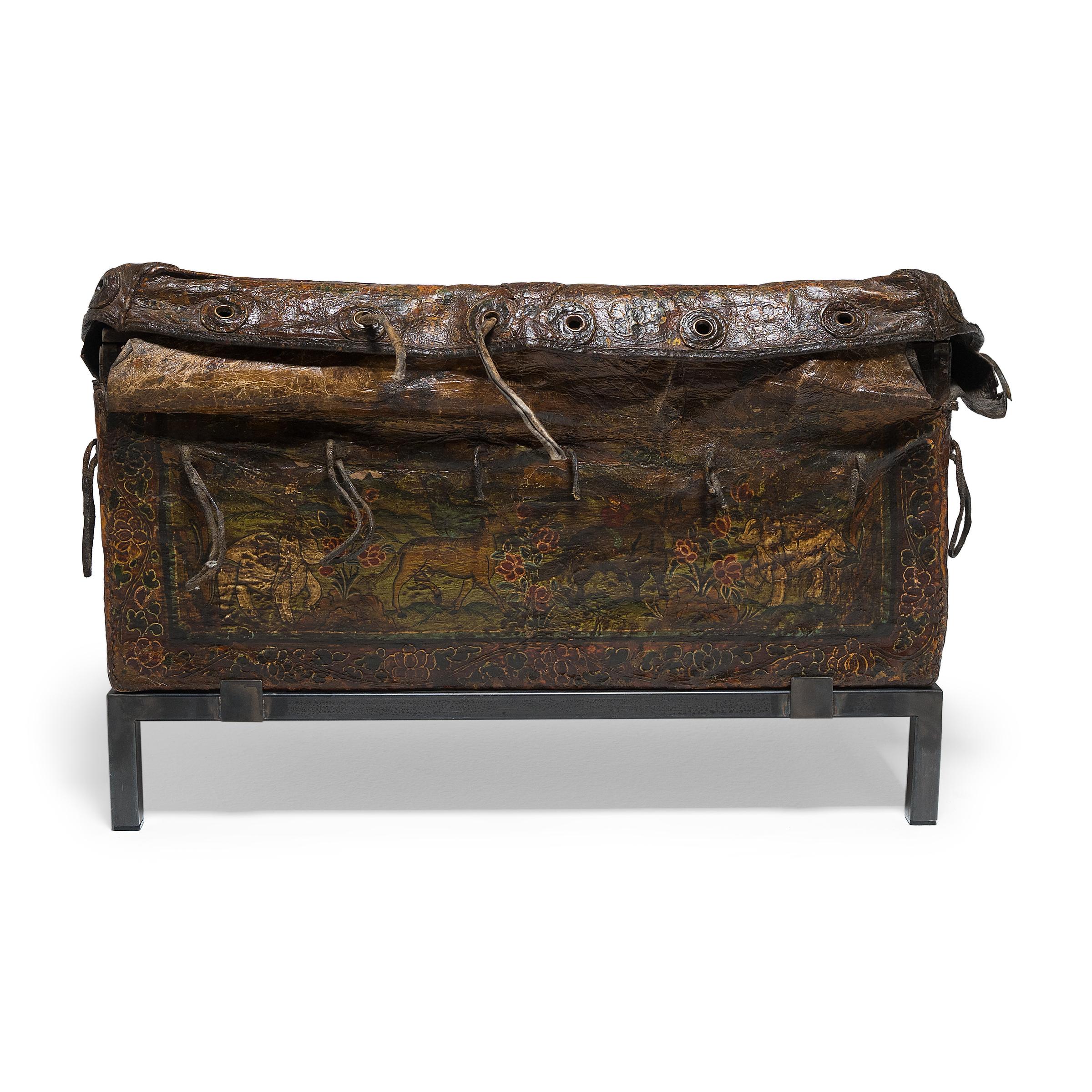 This antique traveler's chest from Tibet or Mongolia is one of the most unique trunks we've come across in our 20 years of collecting. Dated to the 19th century or earlier, the wooden trunk is enclosed by a lacquered hide sheath that folds across