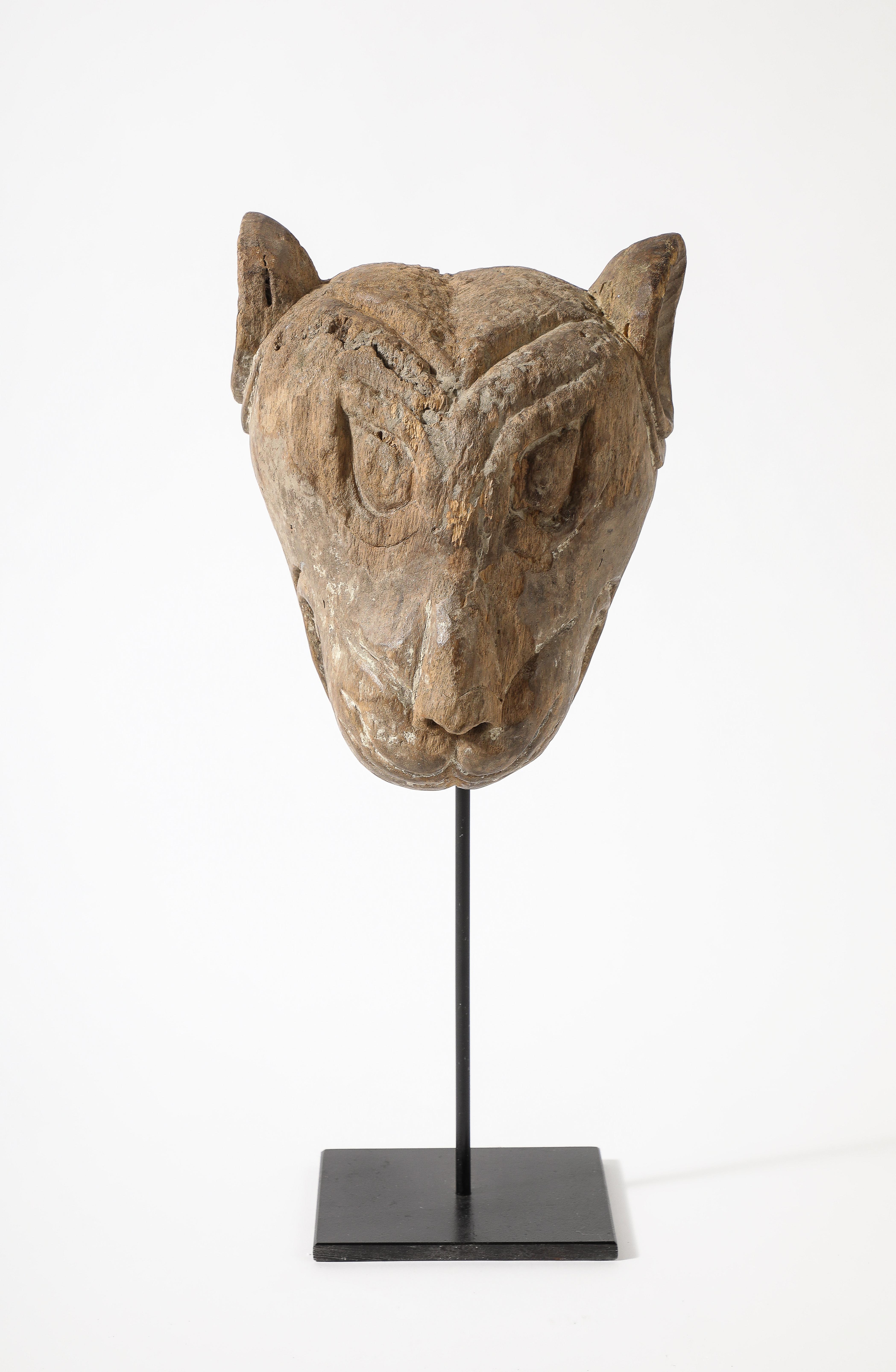 A highly unique and rare Tibetan carved wood lion head sculpture of a temple dog.   This fierce yet friendly looking beast dates from the late 19th Century; executed with masterful craftsmanship by the artisan in hand-carved wood, with dramatic