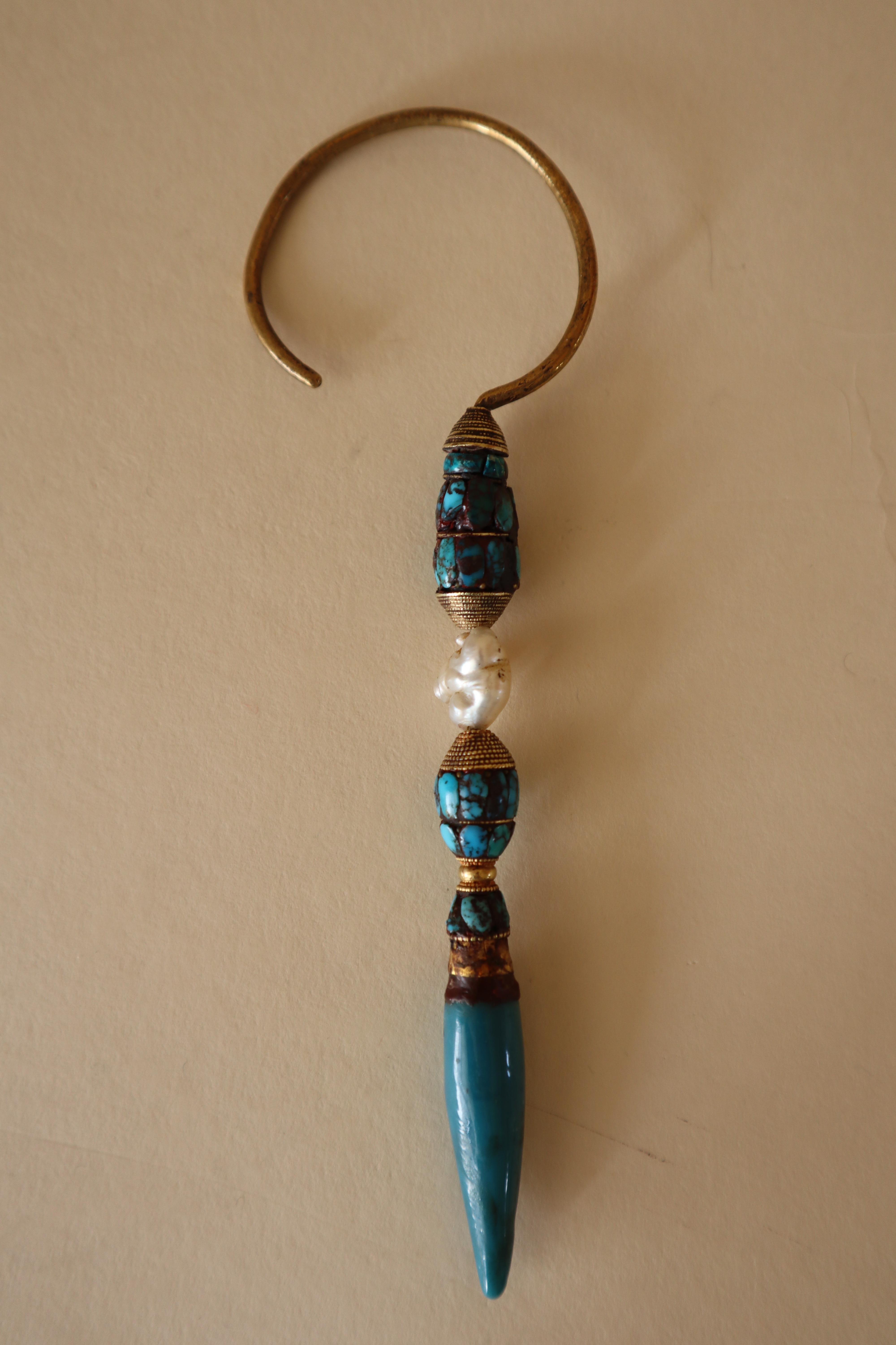 Store closing March 31. Last chance clearance sale.  This magnificent, pencil-like ear ornament is made from a 14-karat gold hoop (tested) and beaded gold wire, gold sheet, a single pearl, turquoise pieces, and a long turquoise-colored glass