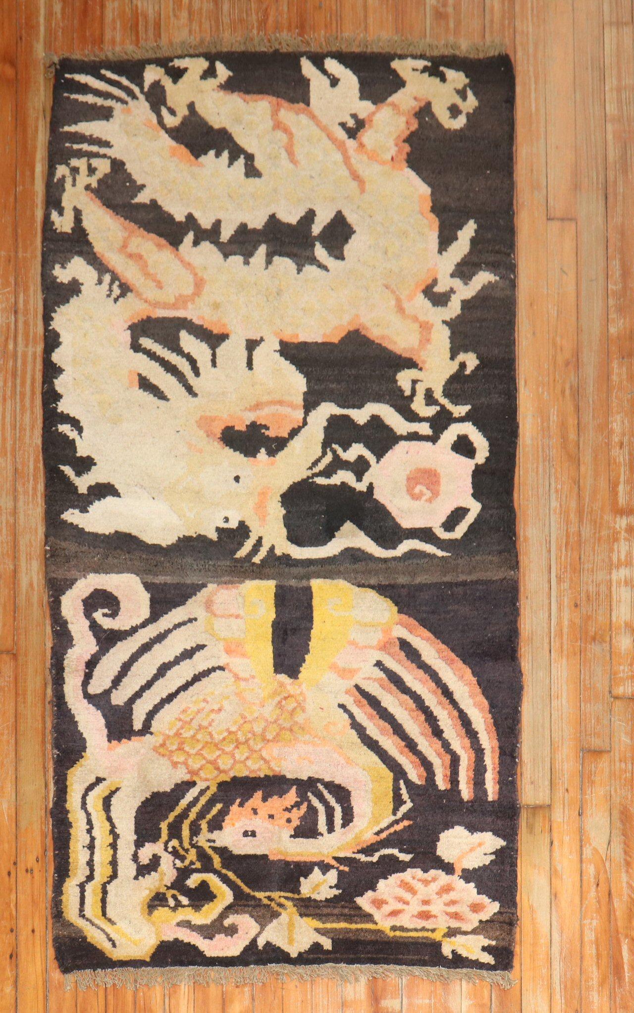 A 2nd quarter of the 20th-century Tibetan rug with a pheonix dragon motif on a brown field

Size: 3' x 5'8''.

