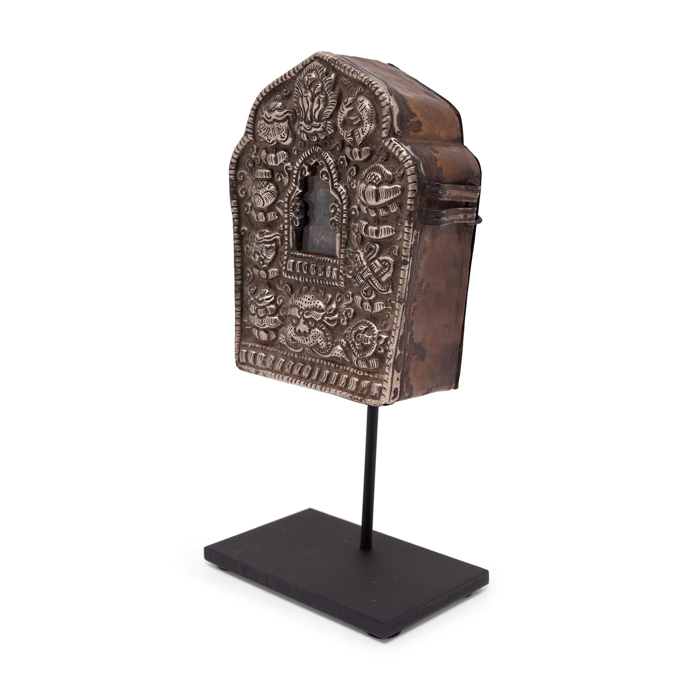 Tibetan traveling shrines, known as Gau, were believed to offer protective powers and were used to hold and carry sacred objects during long journeys. Crafted over a century ago, Buddhist followers may have purchased this intricate gau while on