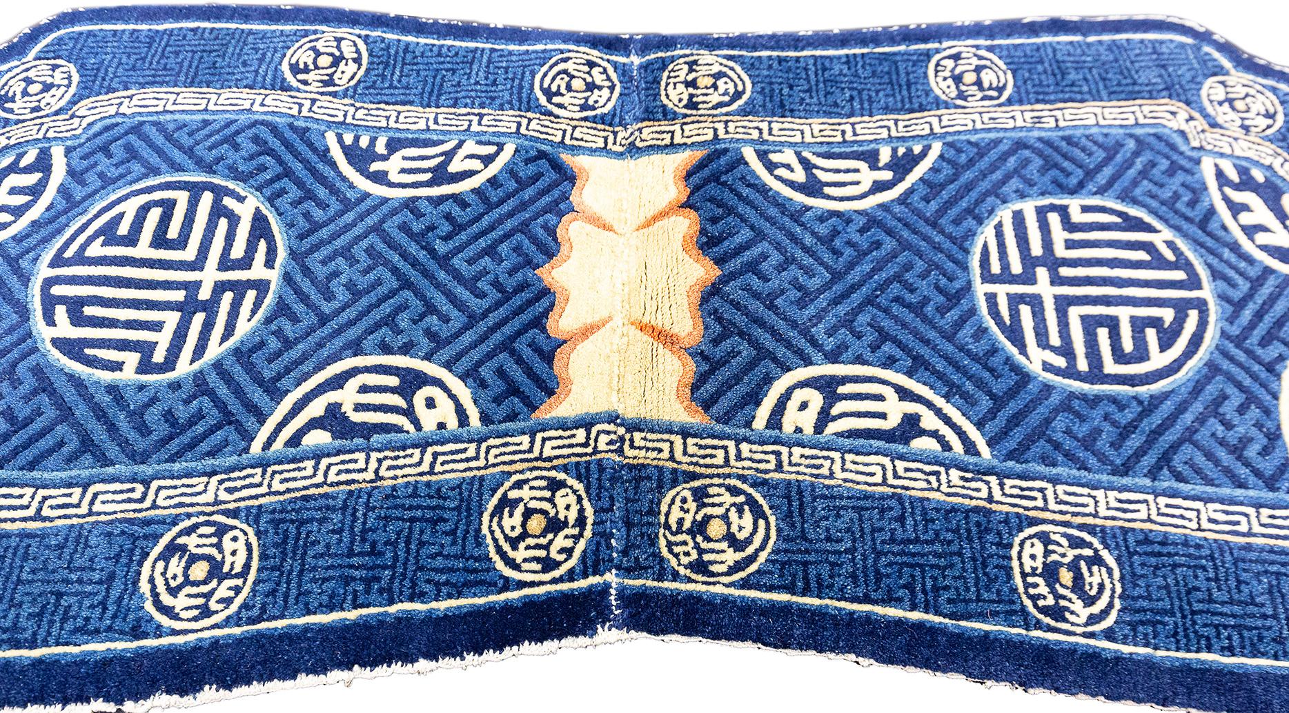 This exquisite Tibetan rug, measuring 120 × 55 cm, is a captivating blend of tradition and artistry, enveloping the viewer in a rich art of cultural motifs and vibrant colors. The rug's unique shape, reminiscent of a sacred Buddhist thangka, draws