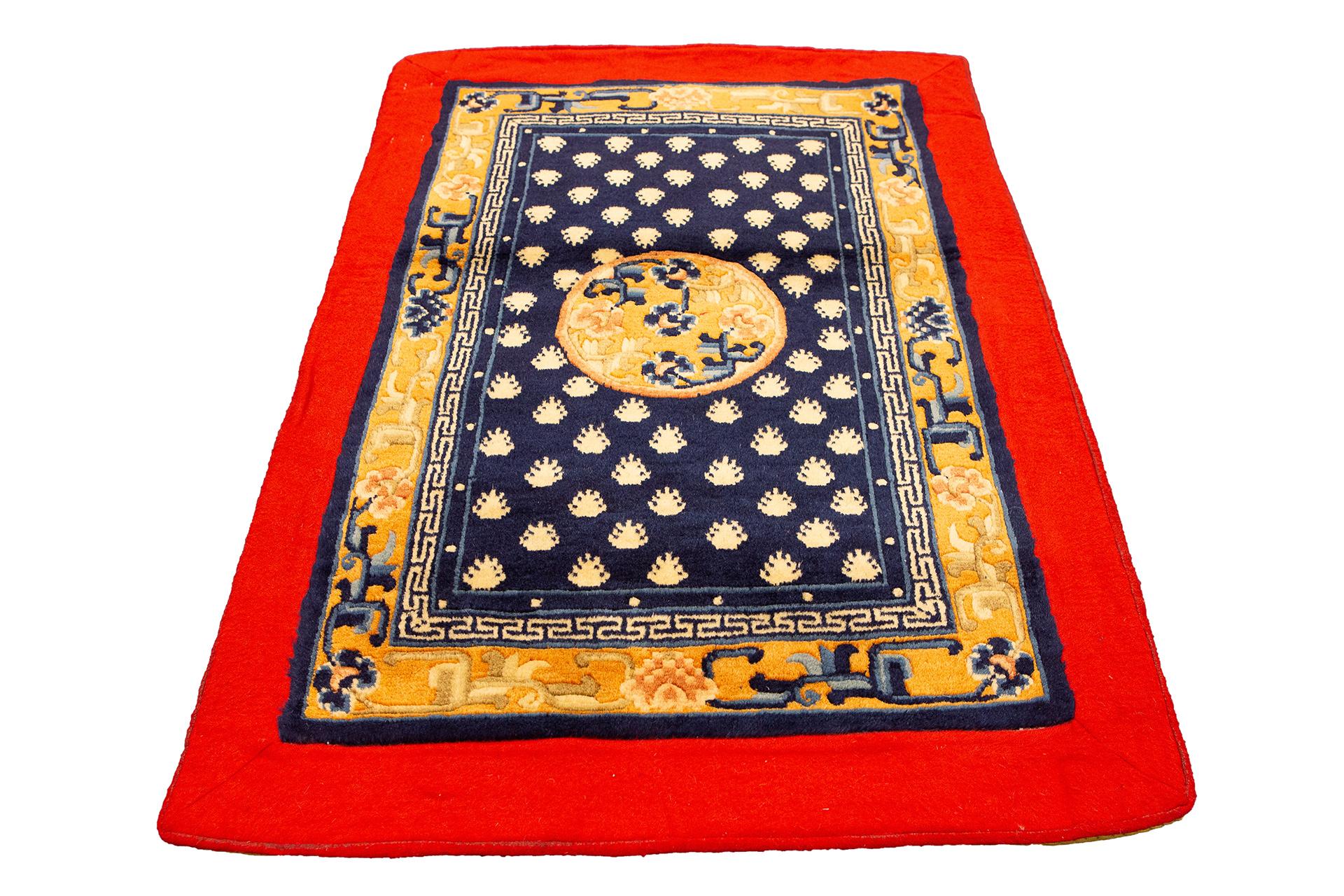 This exquisite Tibetan rug, measuring a compact 86 x 57 cm, is a stunning fusion of vibrant colors and intricate designs, masterfully crafted to capture the essence of Tibetan artistry and culture. This small decorative piece serves as a captivating