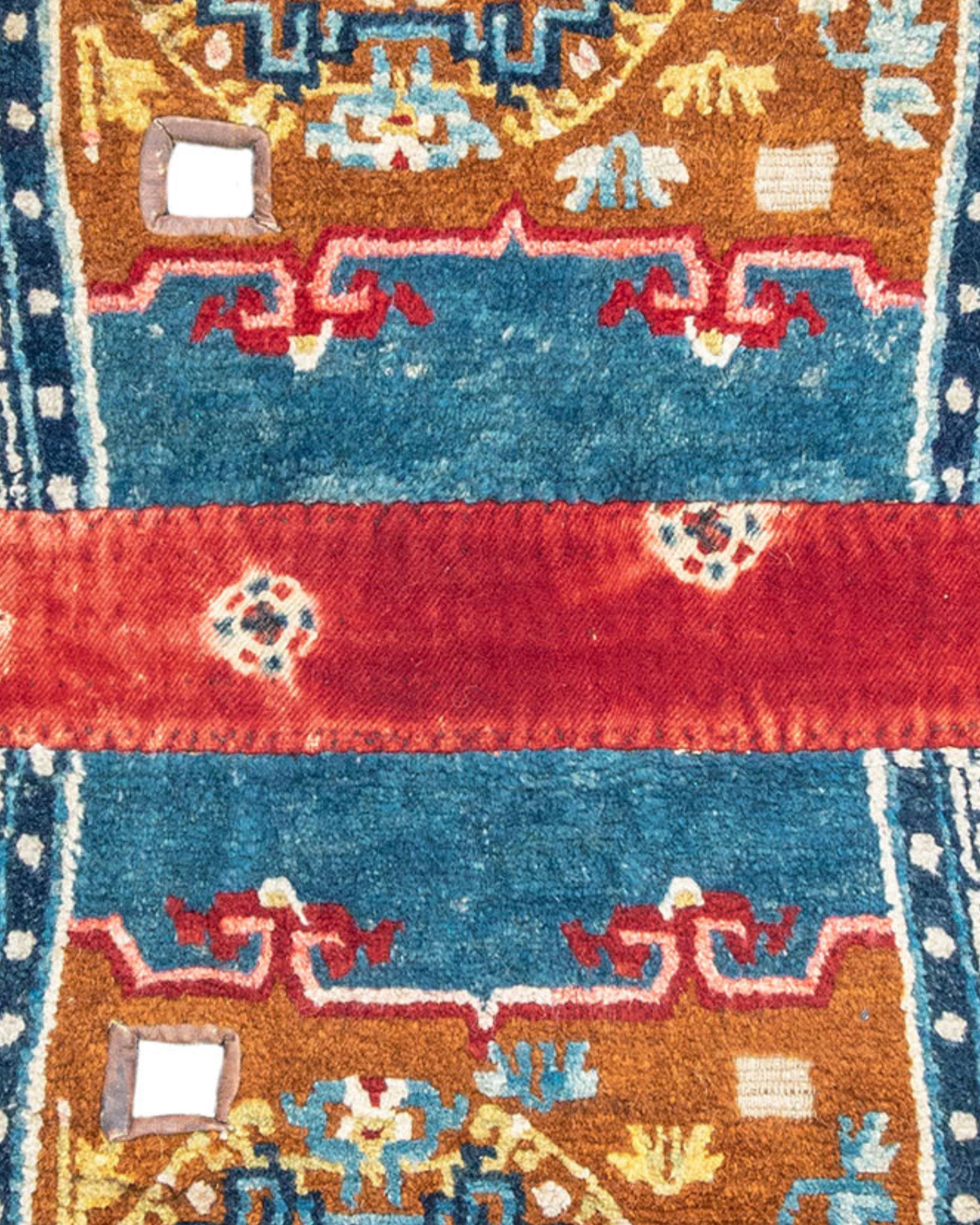 Tibetan Saddle Rug, Late 19th Century

As stated elsewhere and throughout the literature, saddle rugs are not uncommon and appear to be an essential component of the equestrian culture of the high plateau. This example uncharacteristically features