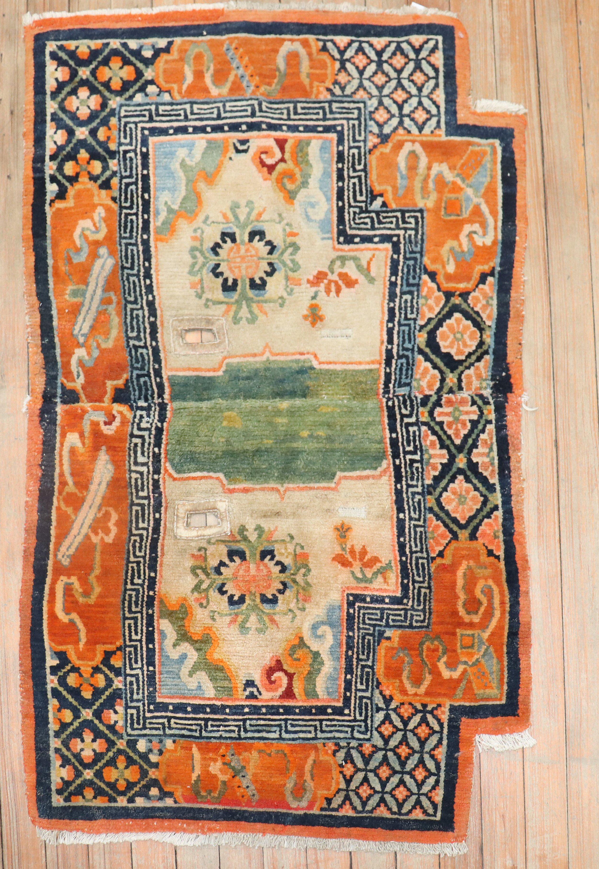 An early 20th century colorful Tibetan textile saddbleback rug.

Measures: 2'2'' x 3'5''.