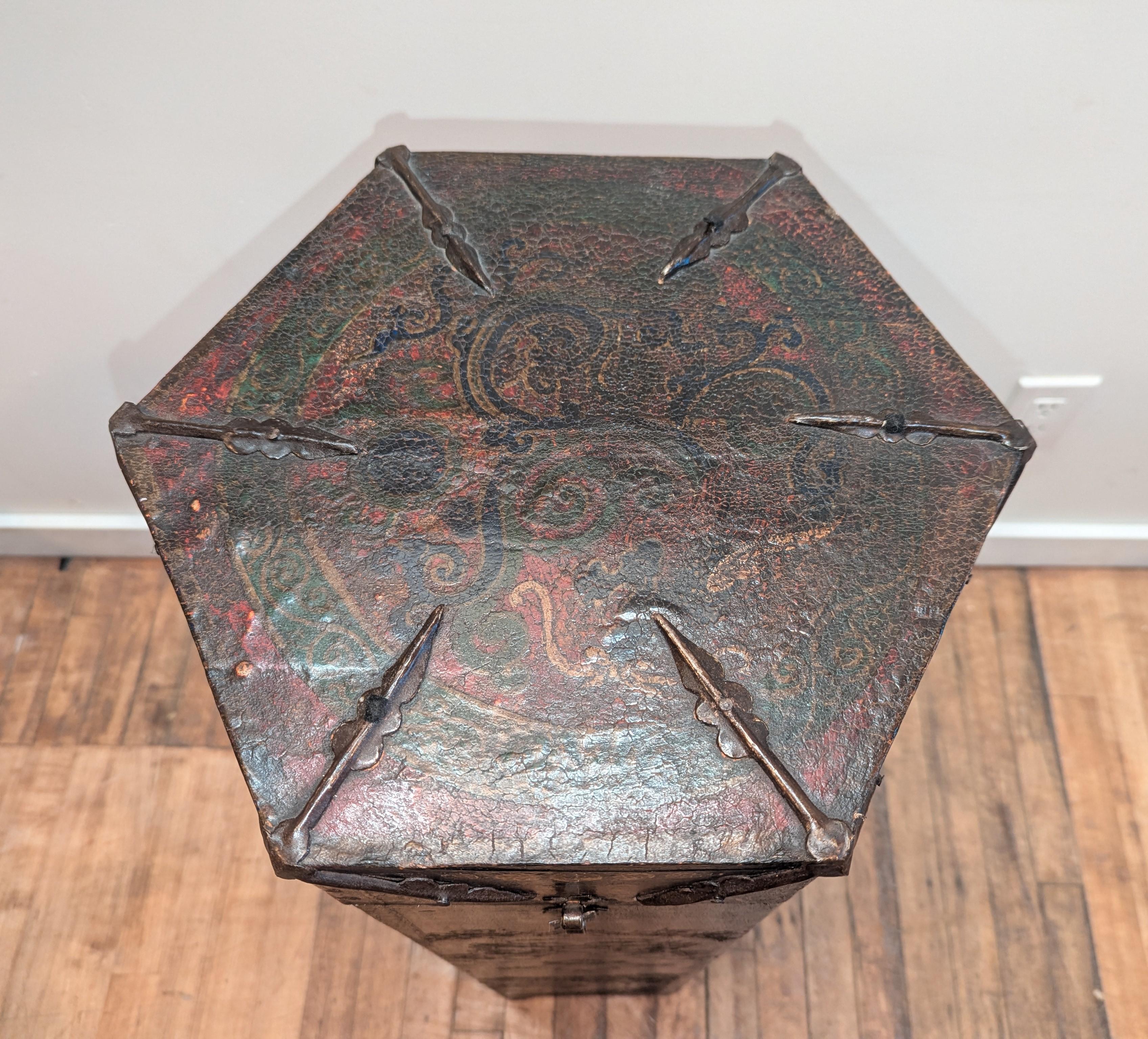 Tibetan hexagon Tonka scroll box. Hand made hexagon box covered in leather hand painted. Traditional Tibetan art work hand painted with raised outlining of Jambhala faces, Tibetan Jewels, and Yin Yang symbols adorn all six sides of this box.