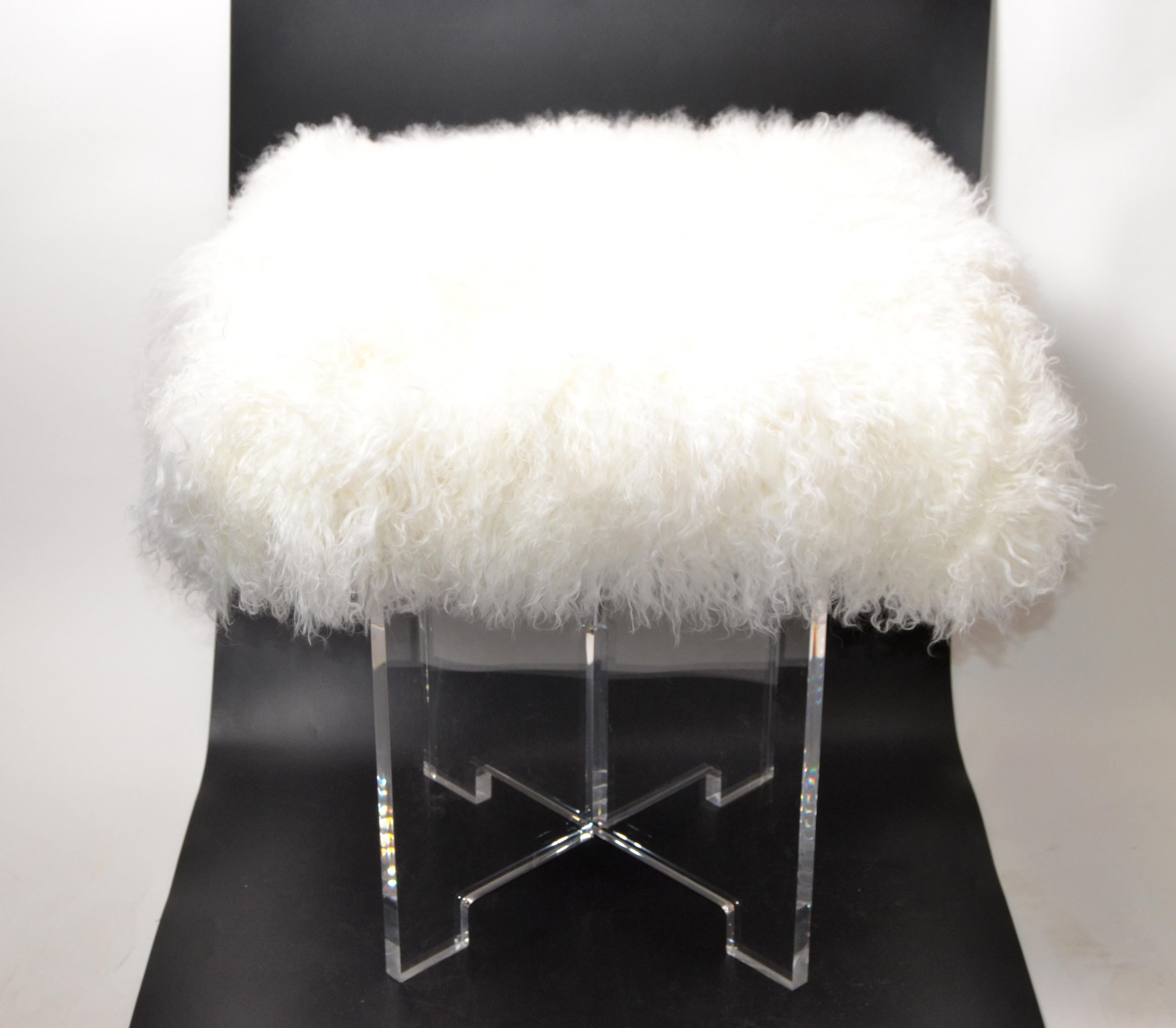 Mid-Century Modern lucite stool, ottoman, small Bench with exotic Tibetan sheepskin in ivory.
Fabulous stool has a sturdy platform supported by a unique x-base.
The Tibetan Sheepskin seating surface is in the original format.
 