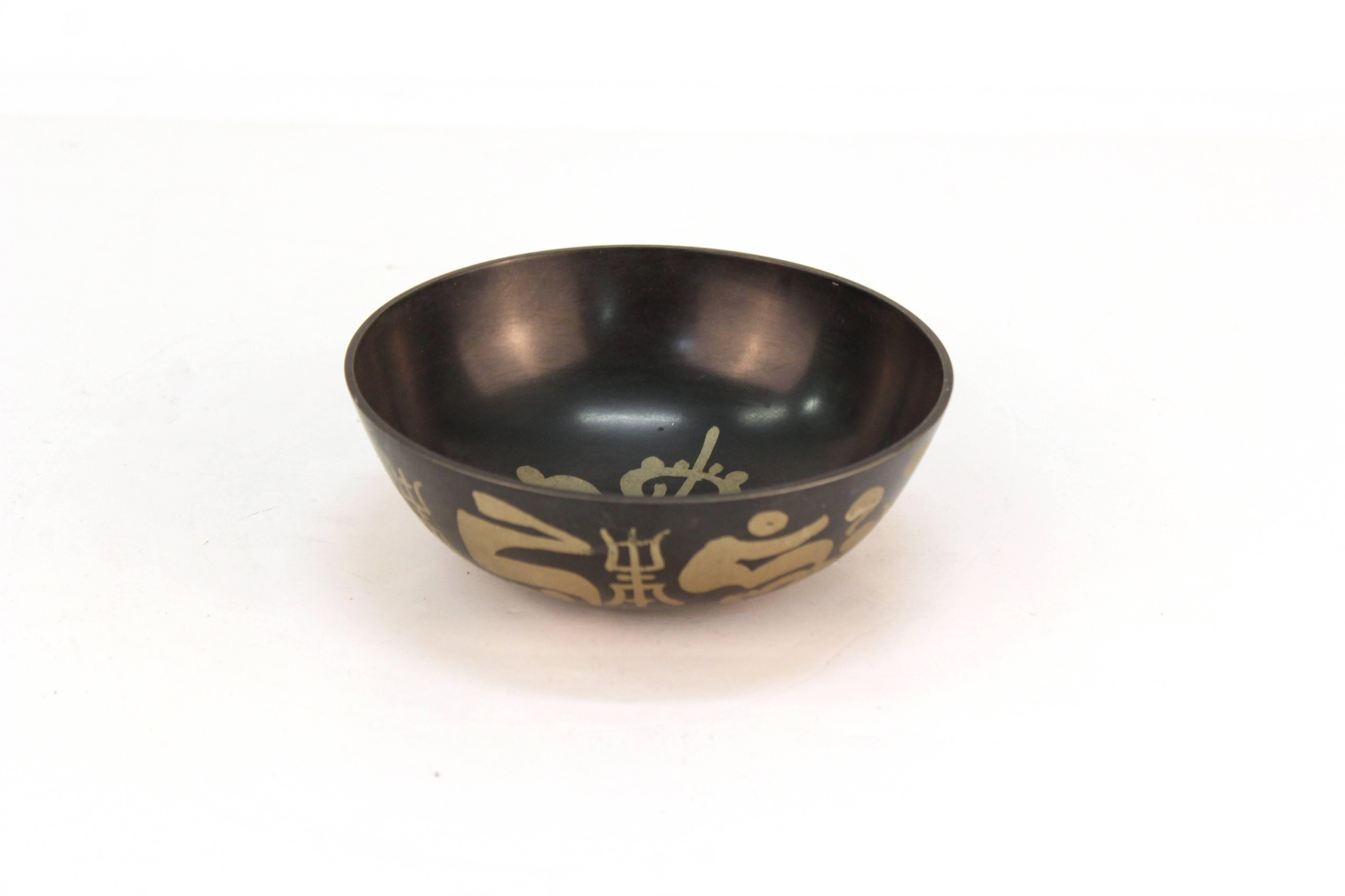 A Tibetan silver and black Kasa metal bowl that is used by monks for singing and begging. The piece is in good vintage condition.