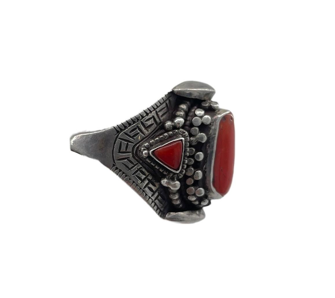 Tibetan coral ring. Coral color is striking. Detailed with Tibetan line work. Adjustable band. Starts at a 9.5 size fully closed. No signature.

Additional information:
Dimensions: 1.5