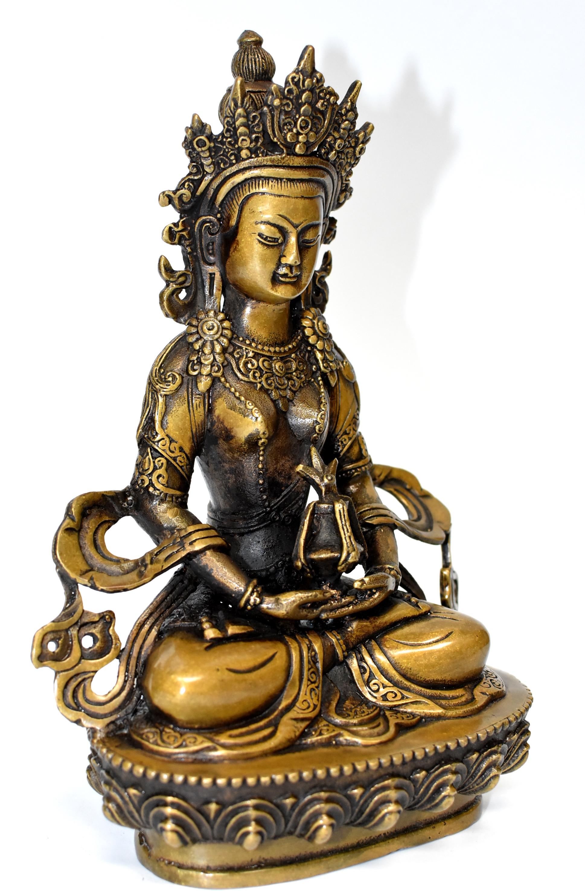 The beautiful bronze sculpture is of The Tibetan Amitayus, the Bodhissatva/Buddha of infinite life. Adorned with necklaces, crown and sashes decorated with rosettes, pearls and medallions, Buddha is seated on a lotus throne, holding Kalasa which is