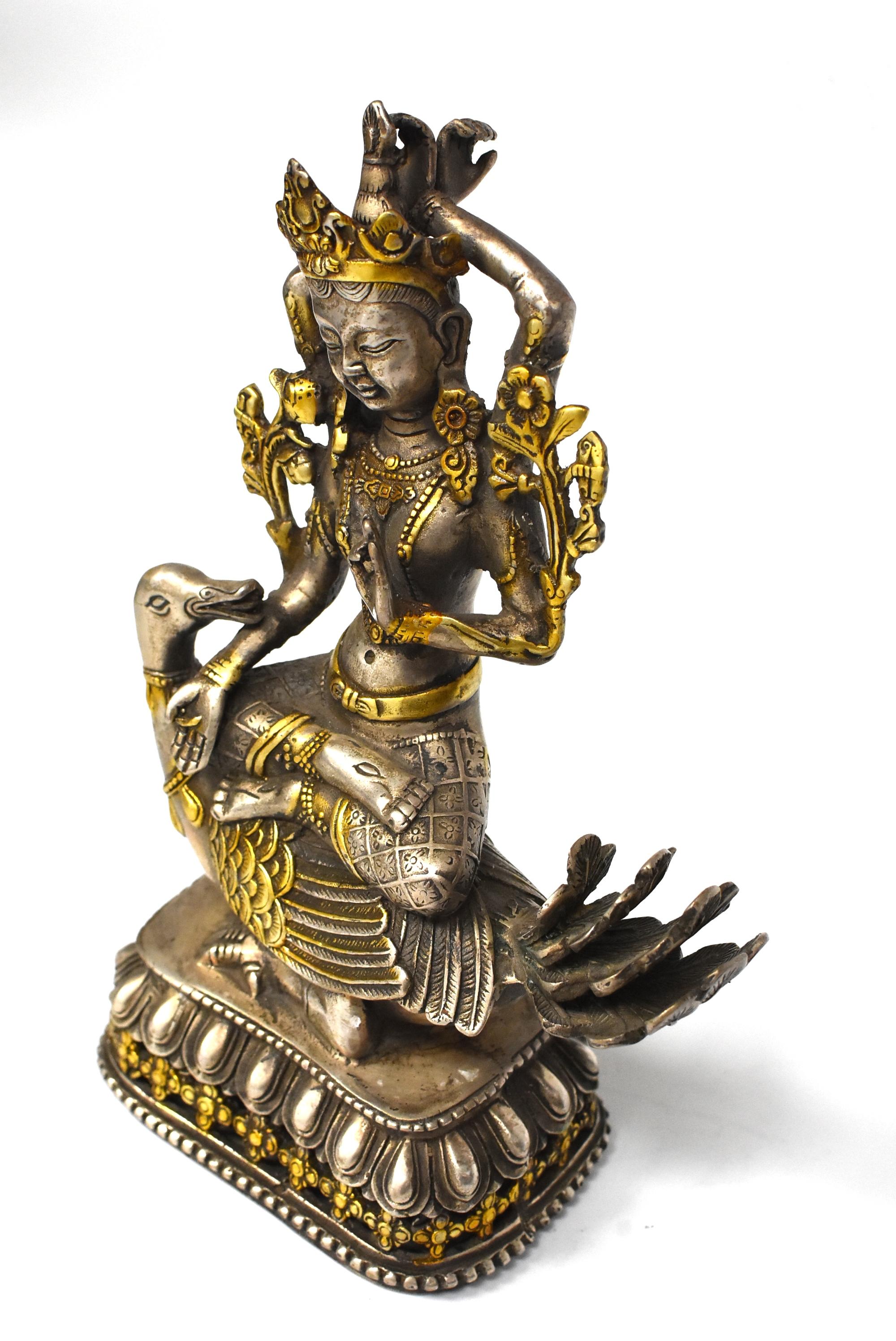 Featured a beautiful silvered bronze sculpture of Tibetan Tara with an recumbent goose. The Tara is decorated with flowers, lariats, ankle bracelets and cuffs. She wears an elaborate crown and is seated on top of a goose above a lotus throne. Tara