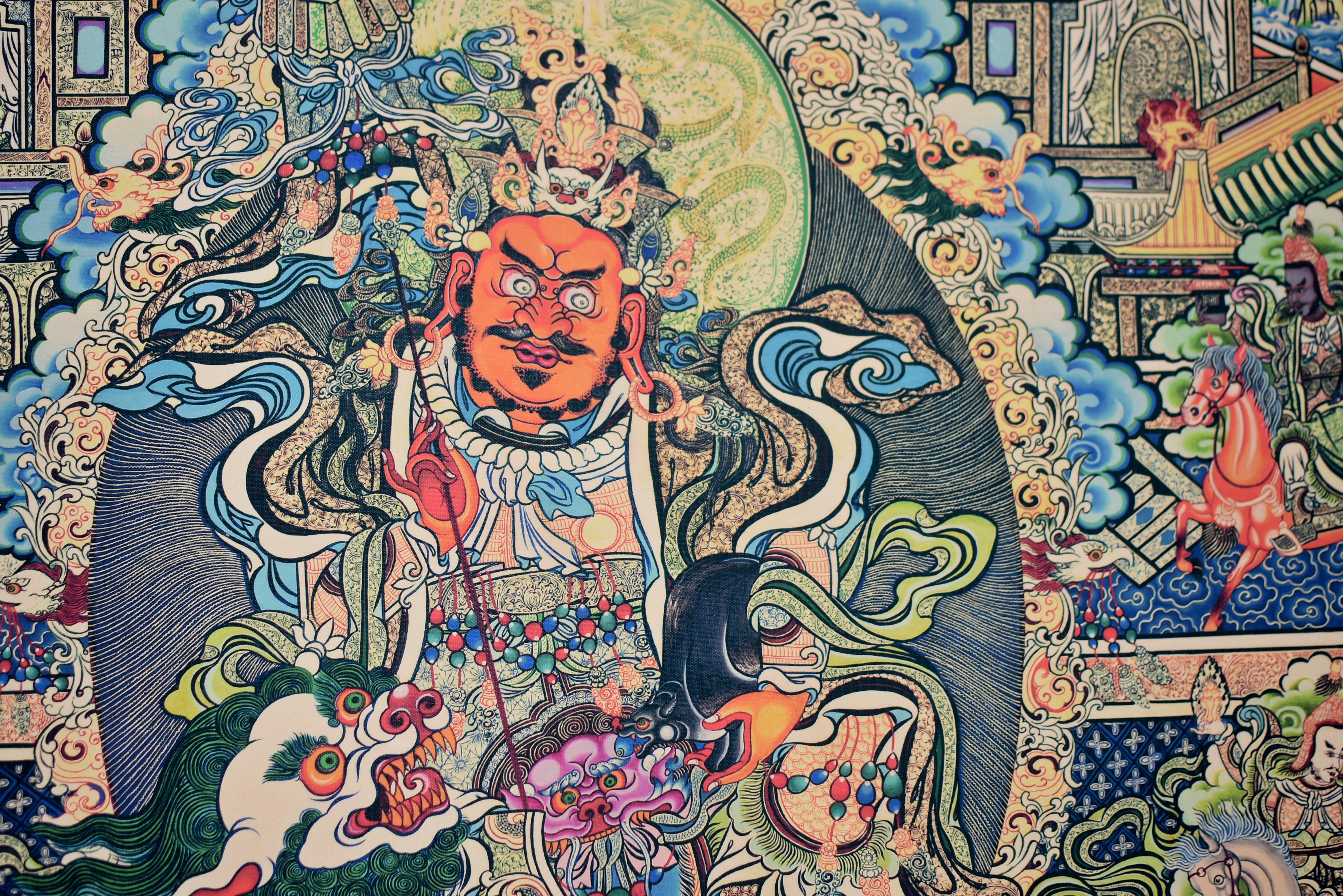A superbly detailed Thangka print depicting the protective Tibetan God Dorje Drolo whose ferocious expression subdues negative and demonic forces. Riding on white lion above a lotus throne, he is backed by the heavenly temple with its garden in full