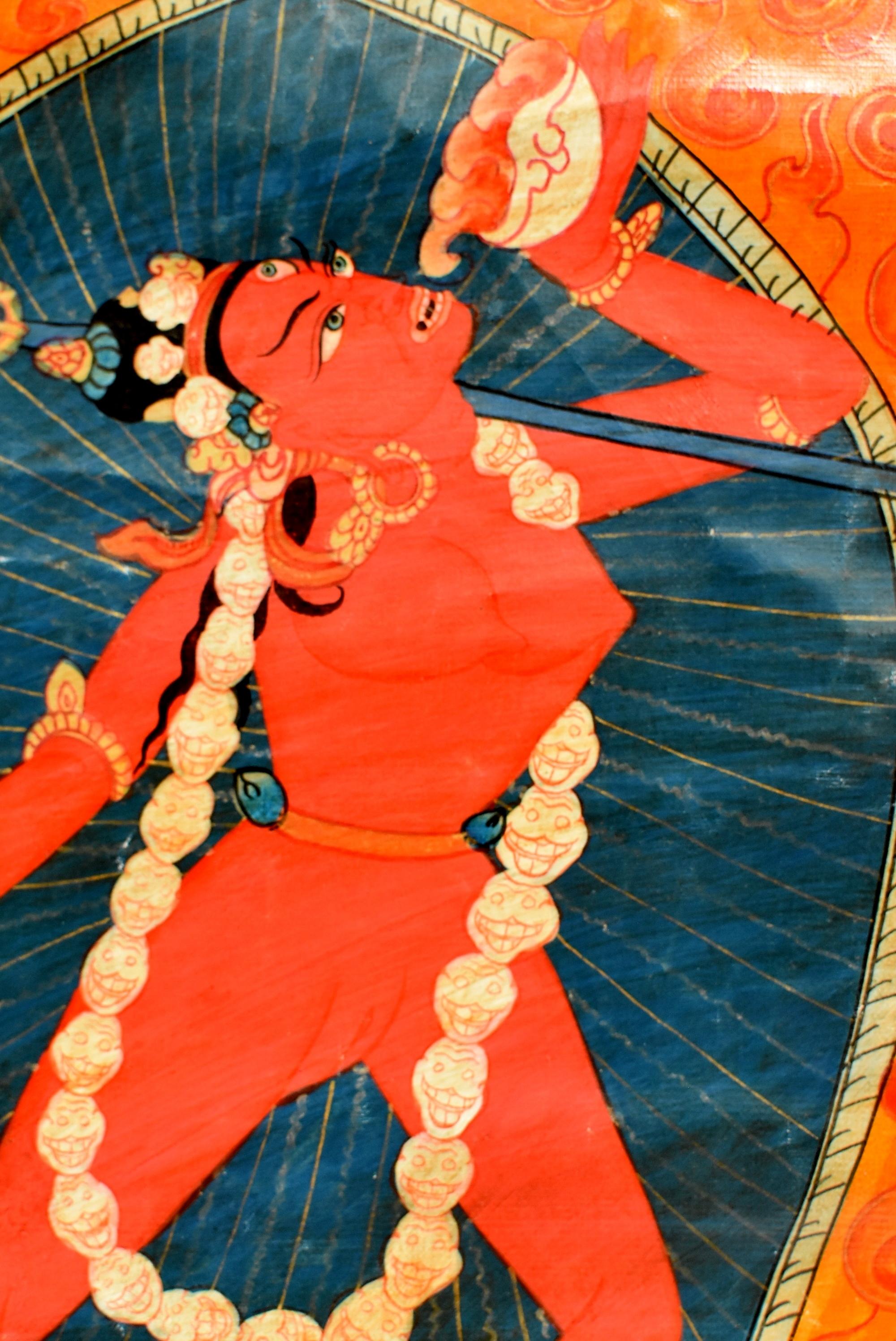 A rare offering. This amazing vintage hand painted Thangka depicts the Tibetan female celestial goddess Dakinis, whose ferocious expression subdues negative and demonic forces. In Alidh Asana posture, she wears a garland of human skulls, with a