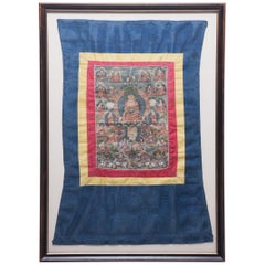 Thangka tibetano di Sakyamuni con broccato di seta, 1880 ca.