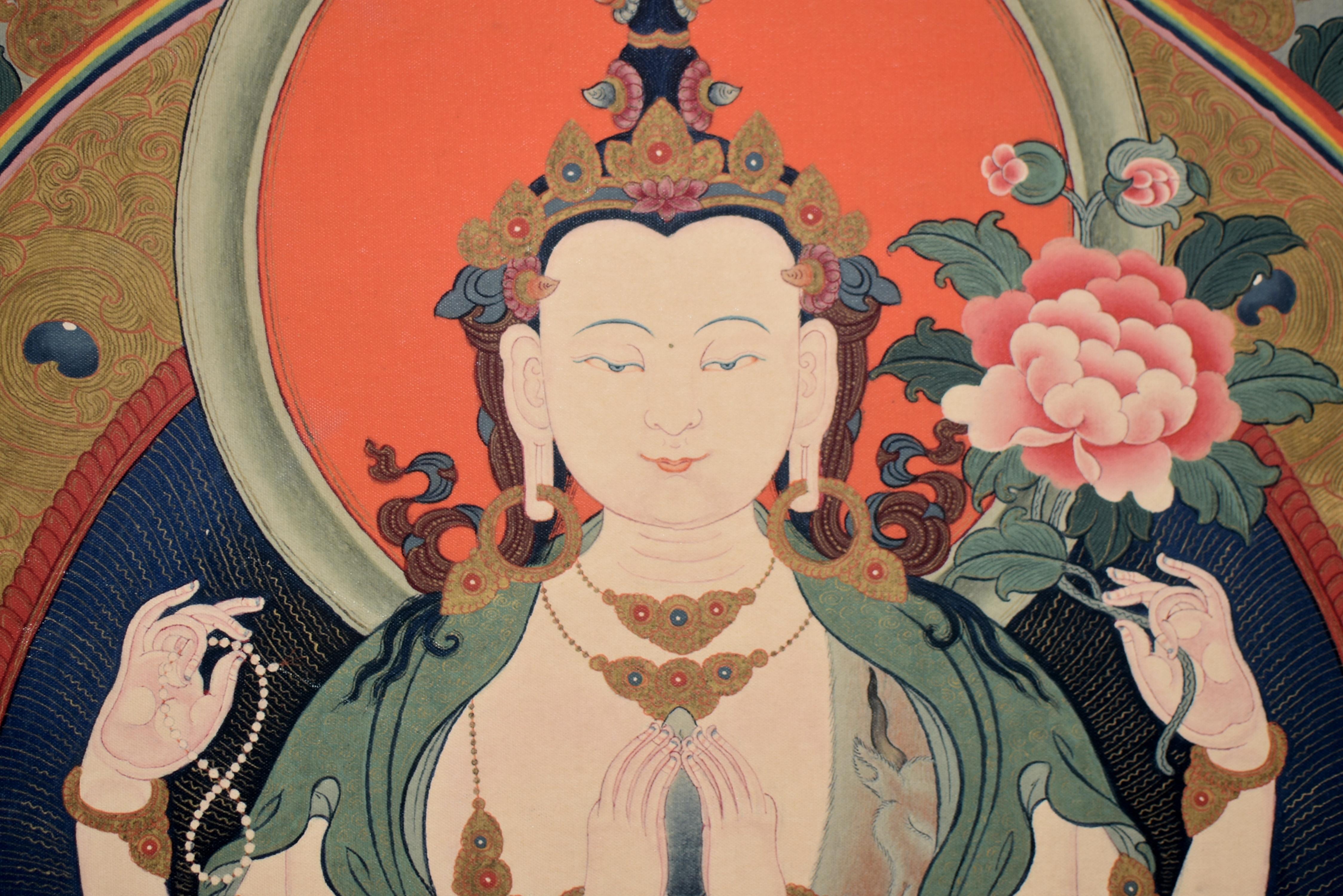 An one of a kind Thangka print depicting the mighty Tibetan White Tara, Goddess of Great Compassion. Seated dhyana asana on lotus throne, rising above prussian blue water with a fortune wheel and blooming lotuses, the full face with large downcast
