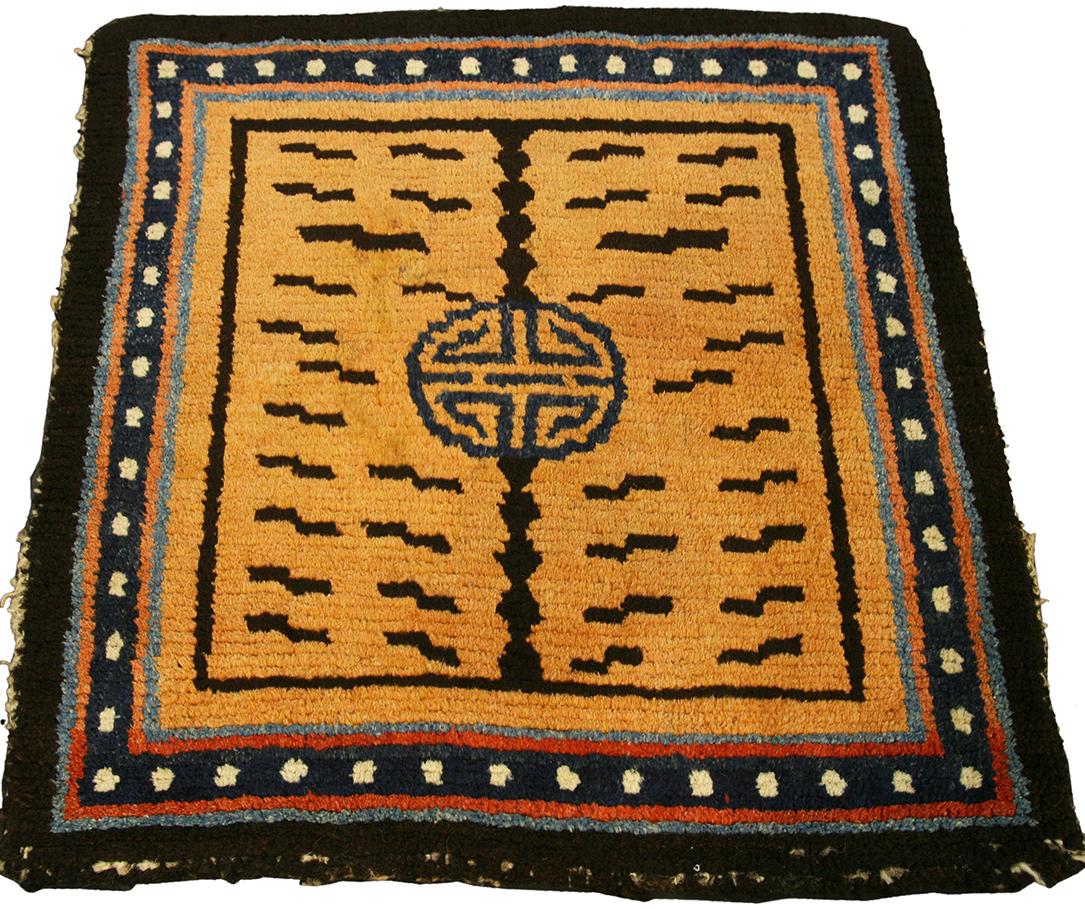 This exquisite Tibetan tiger rug, measuring 69 x 67 cm, is a mesmerizing piece of art that encapsulates the mystical essence of Tibetan culture and craftsmanship. The rug's vibrant design and rich hues create a powerful visual impact, making it a