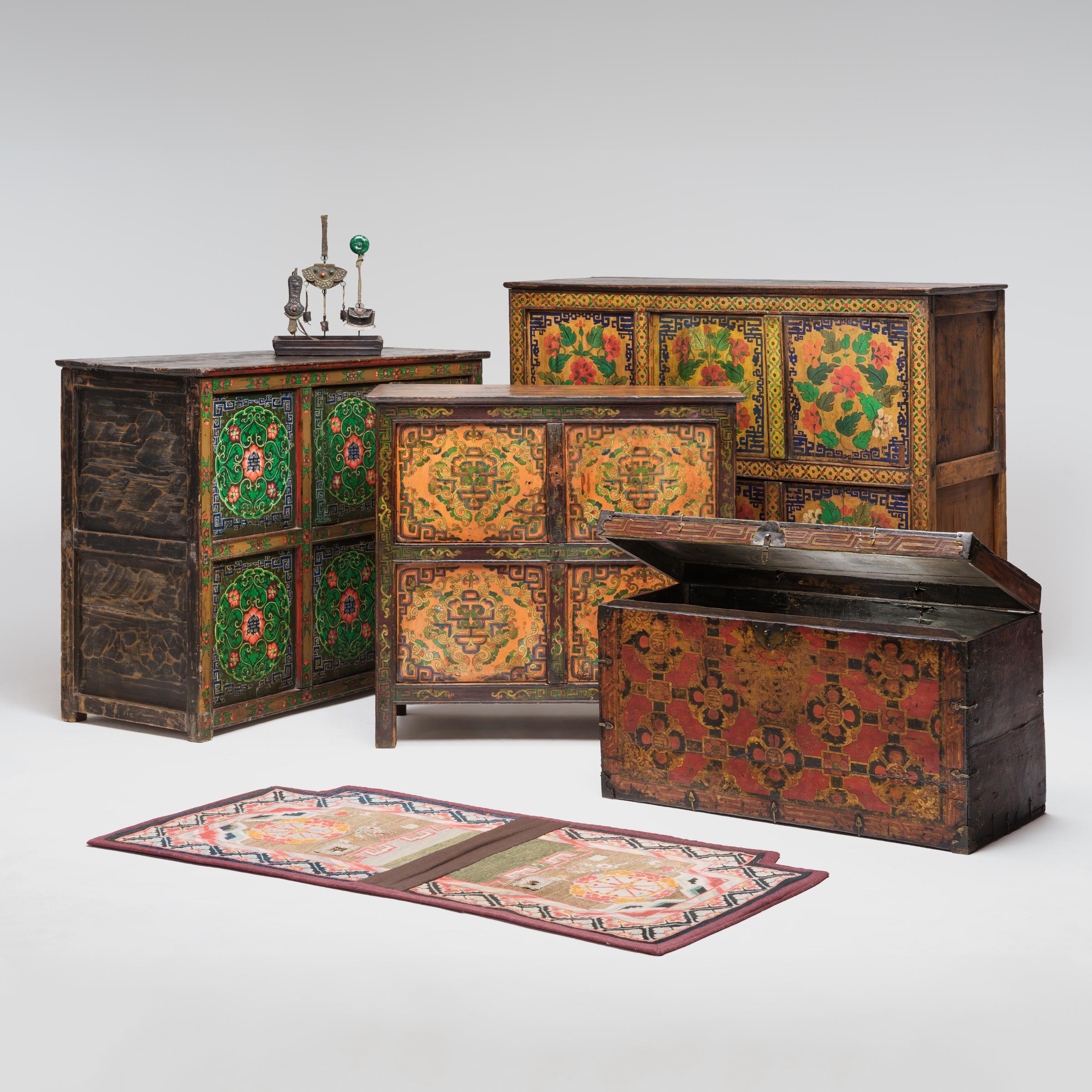 Crafted in late 19th-century Tibet, this charming side cabinet is beautifully decorated in the Sino-Tibetan style with an allover design of trailing vines and geometric scrollwork. A celebration of traditional artistry, the painted design is brushed