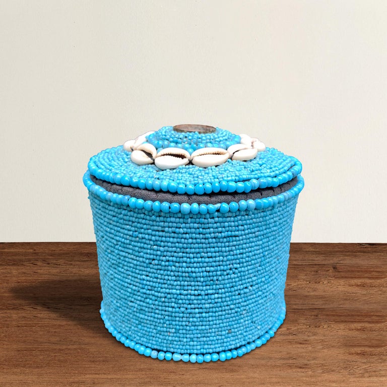 A beautiful contemporary Tibetan round beaded box incorporating thousands of turquoise glass beads and a circle of shells on the lid handstitched onto a black woven cotton lining.