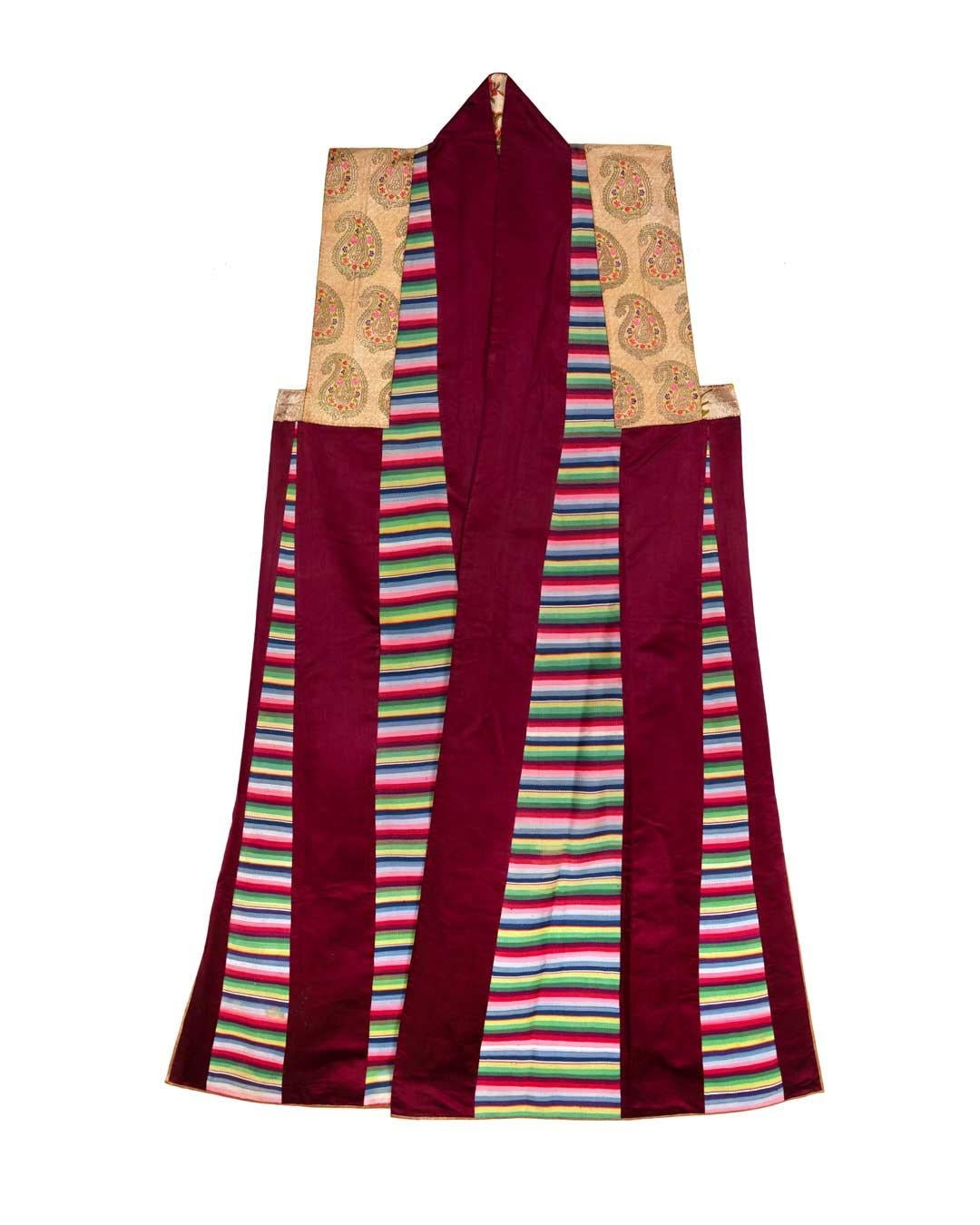 This striking silk long vest was created for a woman in 19th century Tibet. It was worn for special events and ceremonies such as weddings & religious celebrations, with many layers of clothing and jewelry. You can see an image of someone wearing it