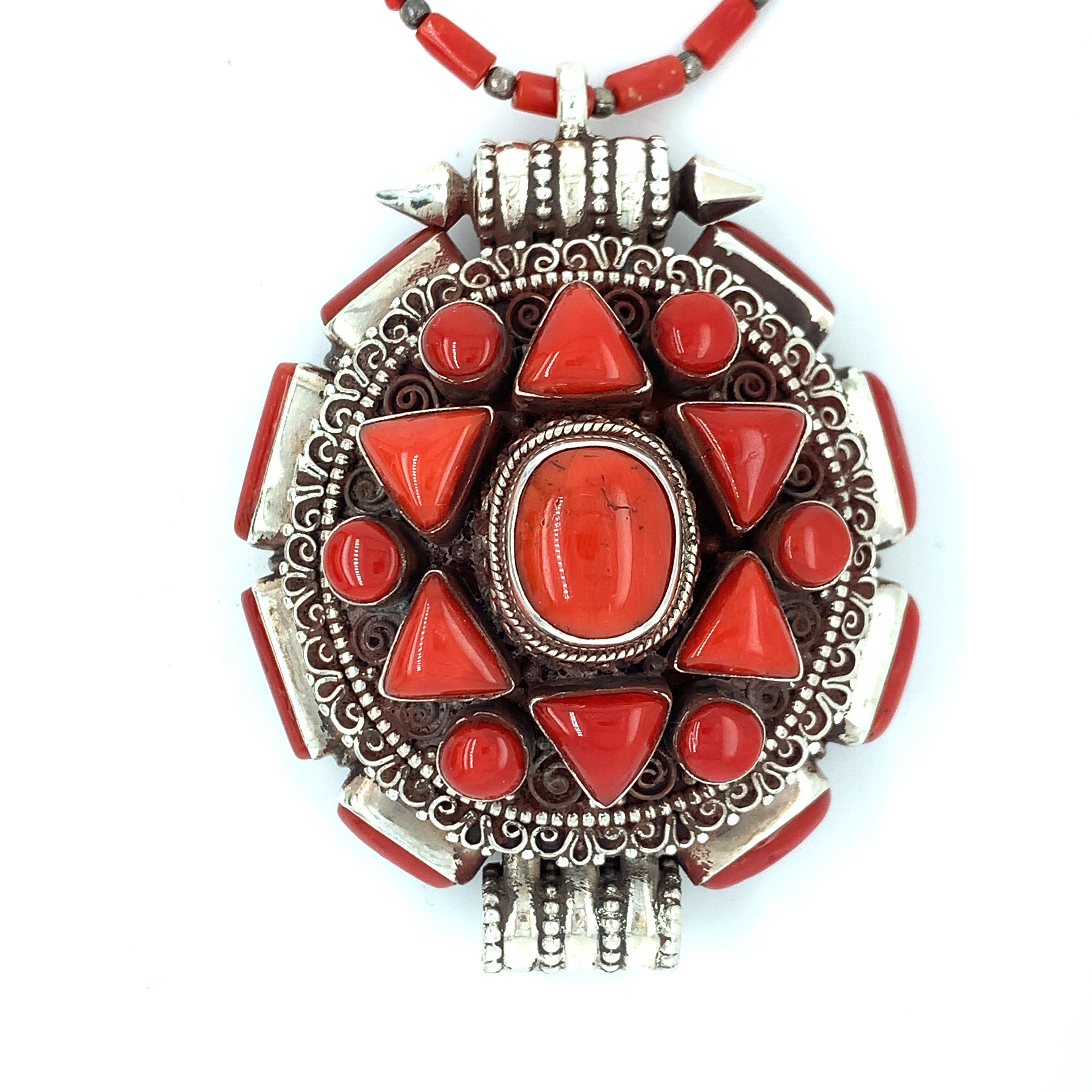Spectacular radiance of these cluster of natural red corals pendant is inspired by Tibetan Ghau Design which includes a coral and silver bead necklace. Ghau Design is similar to a box style which can be opened is a very popular design in Tibetan