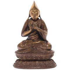 Figura di lama seduto tibeto-cinese, 1900 ca.