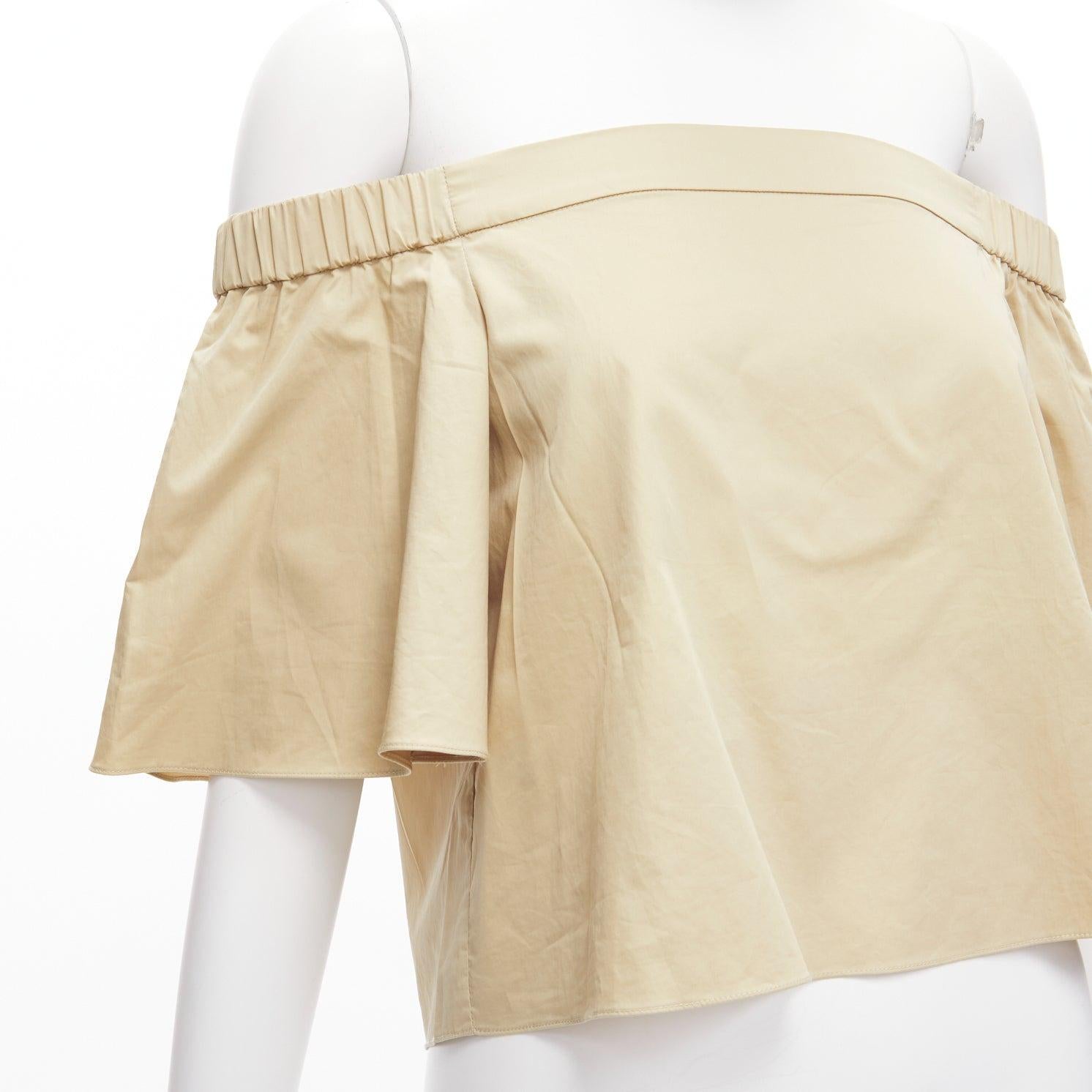 TIBI 100% cotton khaki off shoulder bell sleeves flared cropped top US0 XS
Reference: SNKO/A00389
Brand: Tibi
Material: Cotton
Color: Khaki
Pattern: Solid
Closure: Pullover
Made in: China

CONDITION:
Condition: Excellent, this item was pre-owned and