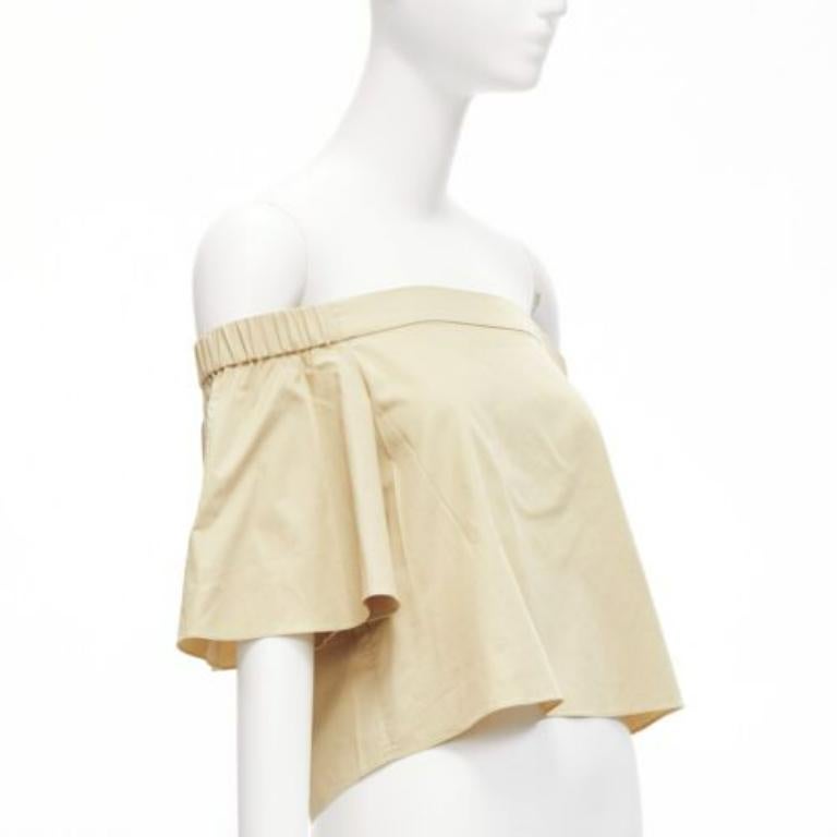 TIBI 100% cotton khaki off shoulder bell sleeves flared cropped top US0 XS
Reference: SNKO/A00389
Brand: Tibi
Material: Cotton
Color: Khaki
Pattern: Solid
Closure: Pullover
Made in: China

CONDITION:
Condition: Excellent, this item was pre-owned and