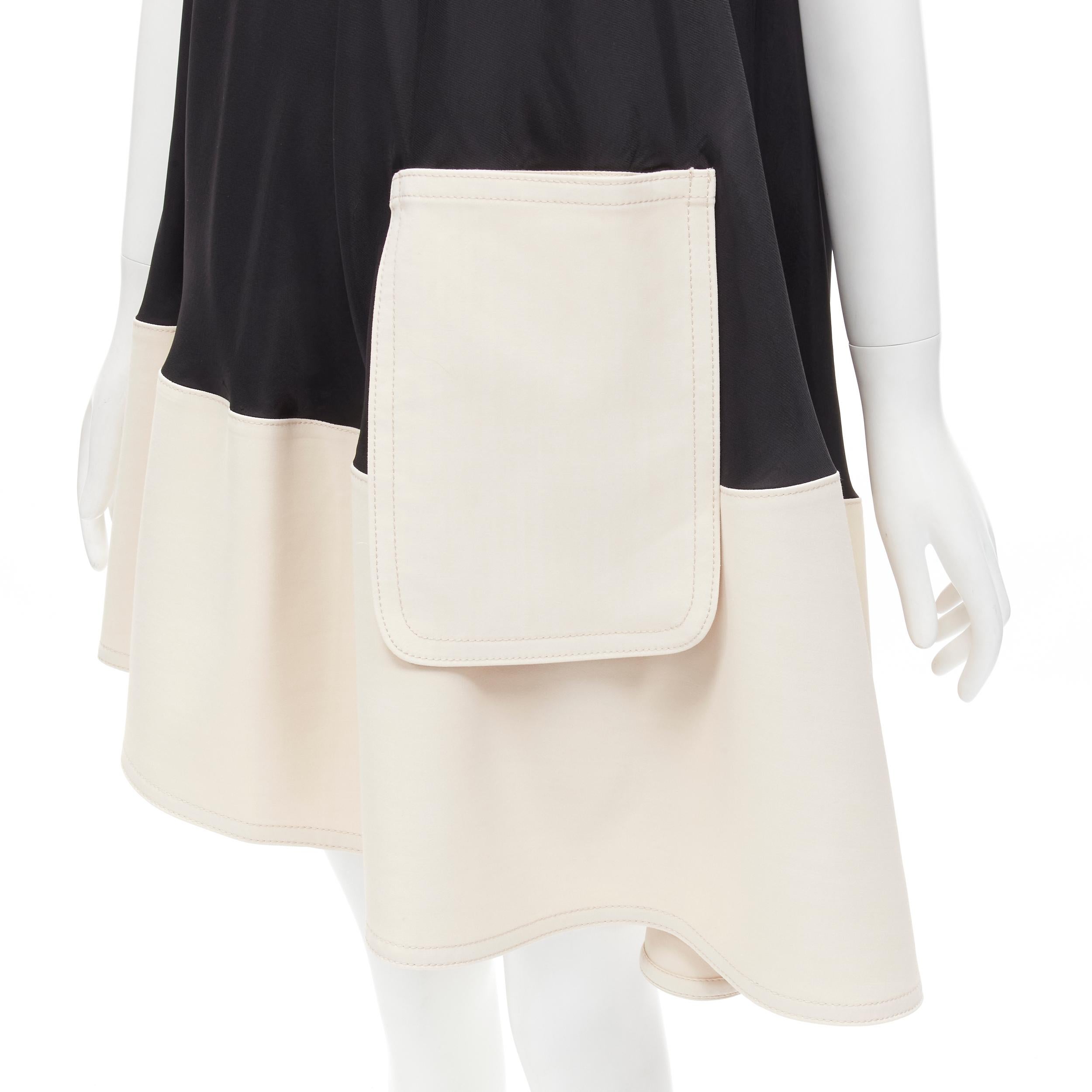 TIBI black beige polyester patch pocket buckle halter A-line dress US2 S
Brand: Tibi
Material: Polyester
Color: Black
Pattern: Solid
Extra Detail: Elasticated buckle halter collar. Patch pocket design. Weighted cotton at hem for structure.
Made in: