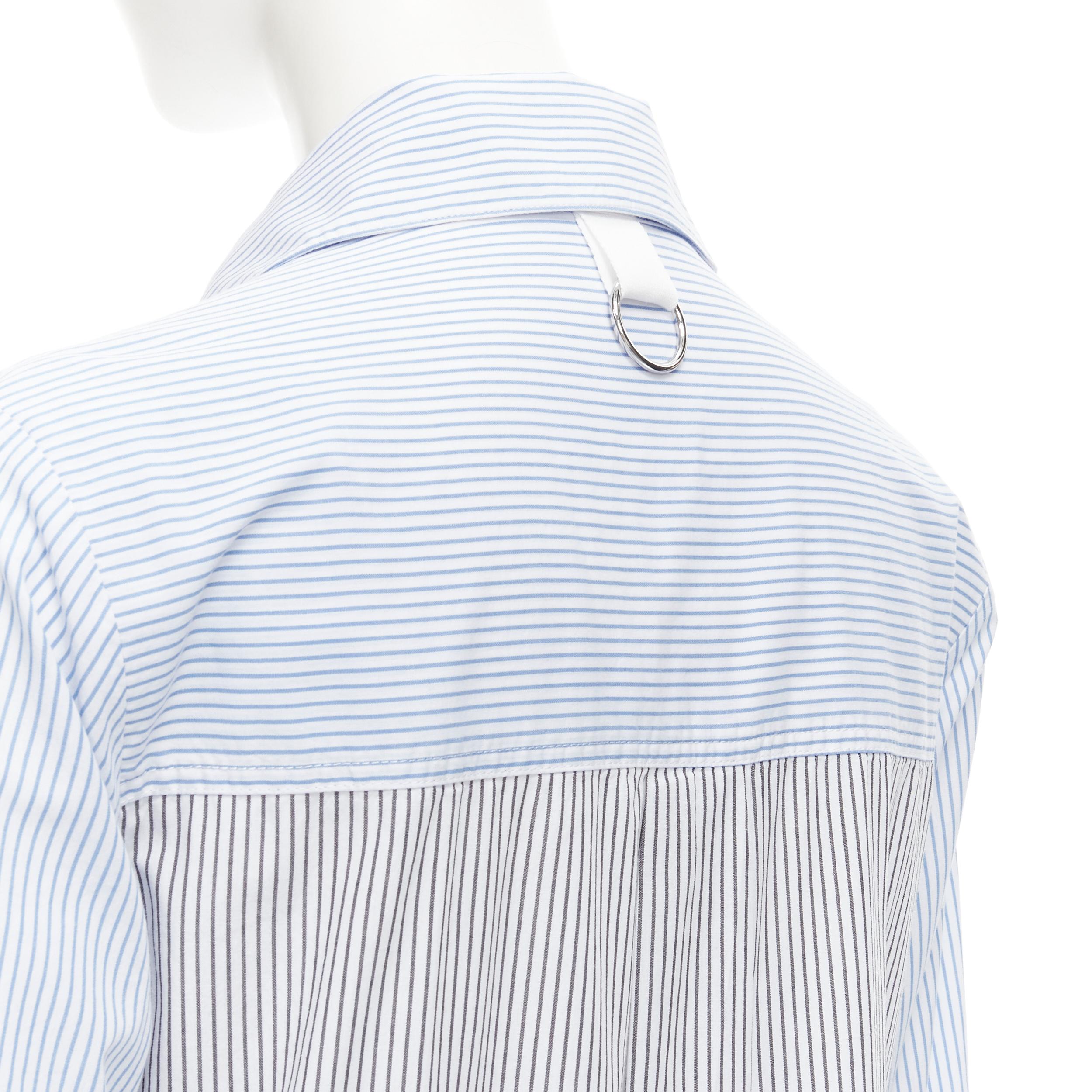 TIBI blue grey striped cotton asymmetric pockets flutter skirt shirt dress XS 
Reference: CECU/A00012 
Brand: Tibi 
Material: Cotton 
Color: Blue 
Pattern: Striped 
Closure: Button 
Extra Detail: Asymmetric pocket designs. Dual front pockets at