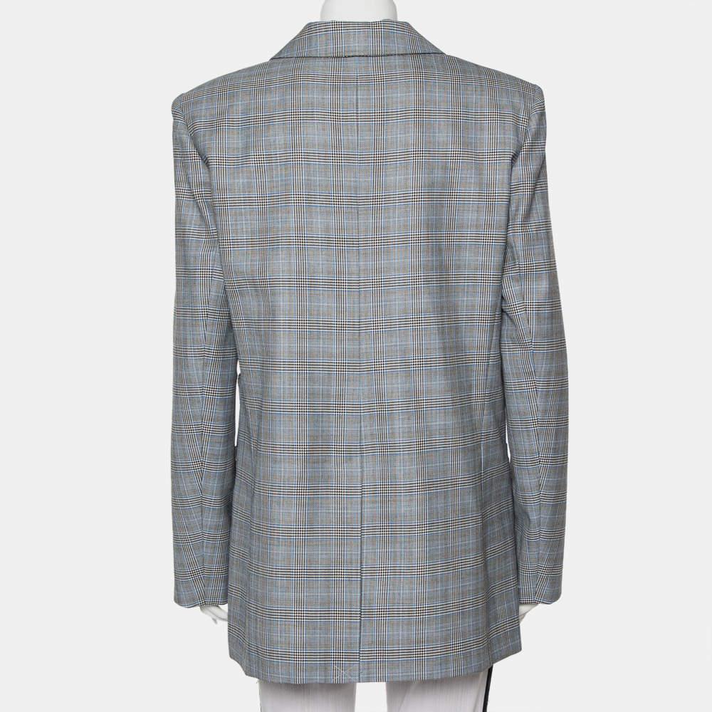 This suave Tibi blazer defines power dressing in the most effortless way. Tailored from silk and wool in a grey shade, it features a plaided design all over, notch lapels, padded shoulder for a defined appeal. The creation is adorned with cut-outs