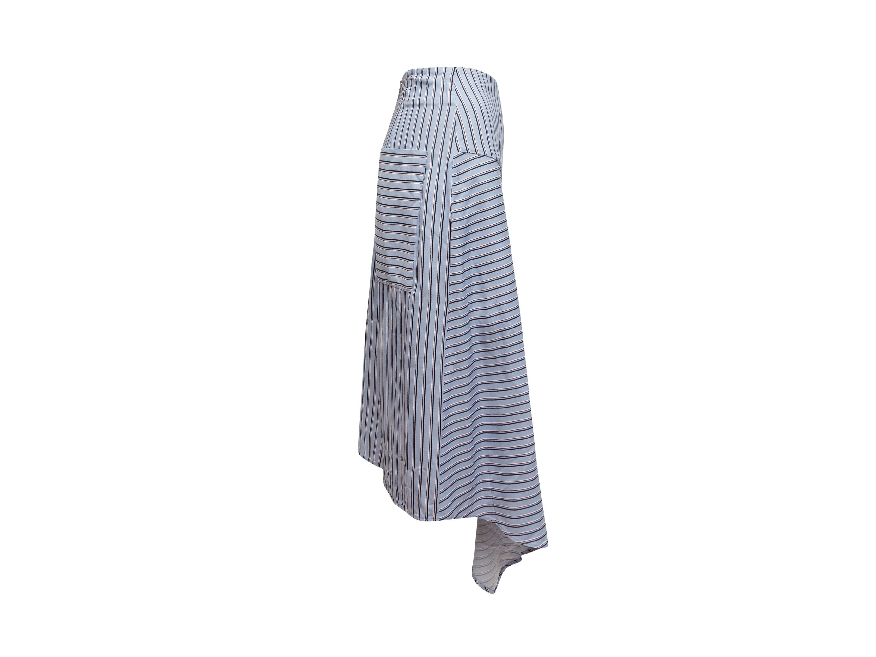 Product details: Light blue and multicolor striped midi skirt by Tibi. Asymmetrical hem. Dual patch pockets at back. Buckle accent at hip. Zip closure at center back. 32.5