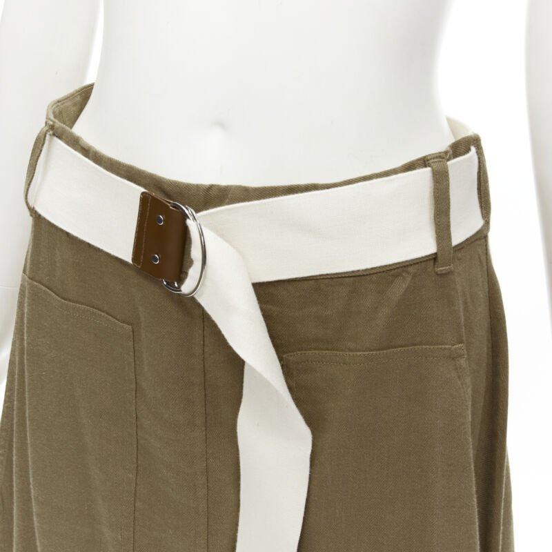 TIBI safari marrone in misto lino con cintura e gonna midi US6 S
Riferimento: KNLM/A00195
Marchio: Tibi
Materiale: Lino, Viscosa
Colore: Marrone, Beige
Modello: Tinta unita
Chiusura: bottone
Dettagli extra: Gonna avvolgente con cintura attaccata e