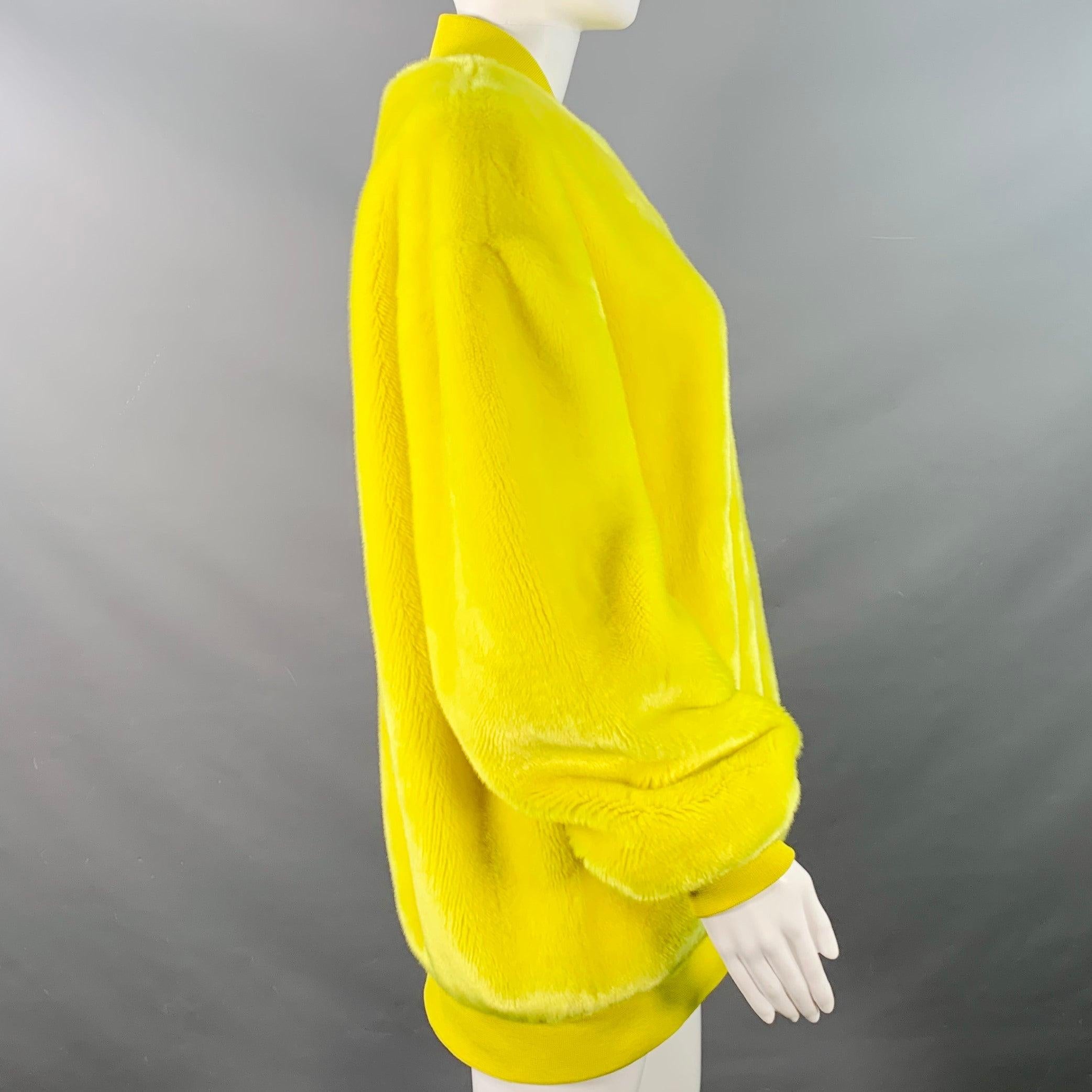 TIBI bomber jacket in a yellow acrylic faux fur featuring rib knit trim, oversized fit, and zip up closure.Very Good Pre-Owned Condition. Minor mark on back, and signs of wear on zipper pulls. 

Marked:   M 

Measurements: 
 
Shoulder: 20.5 inches