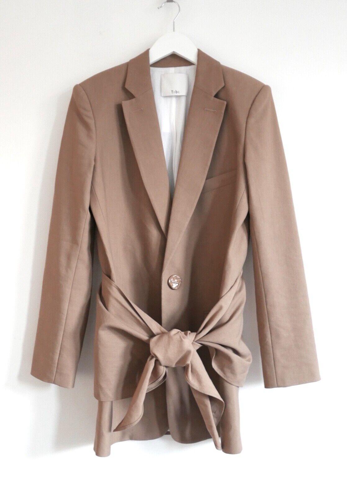 Super chic and versatile Tibi tie front blazer dress. Bought for €850 and worn once. Made from naturally slub camel colored viscose, linen and cotton with simple textured front buttons. It features a removable tie panel at the hips that can also be