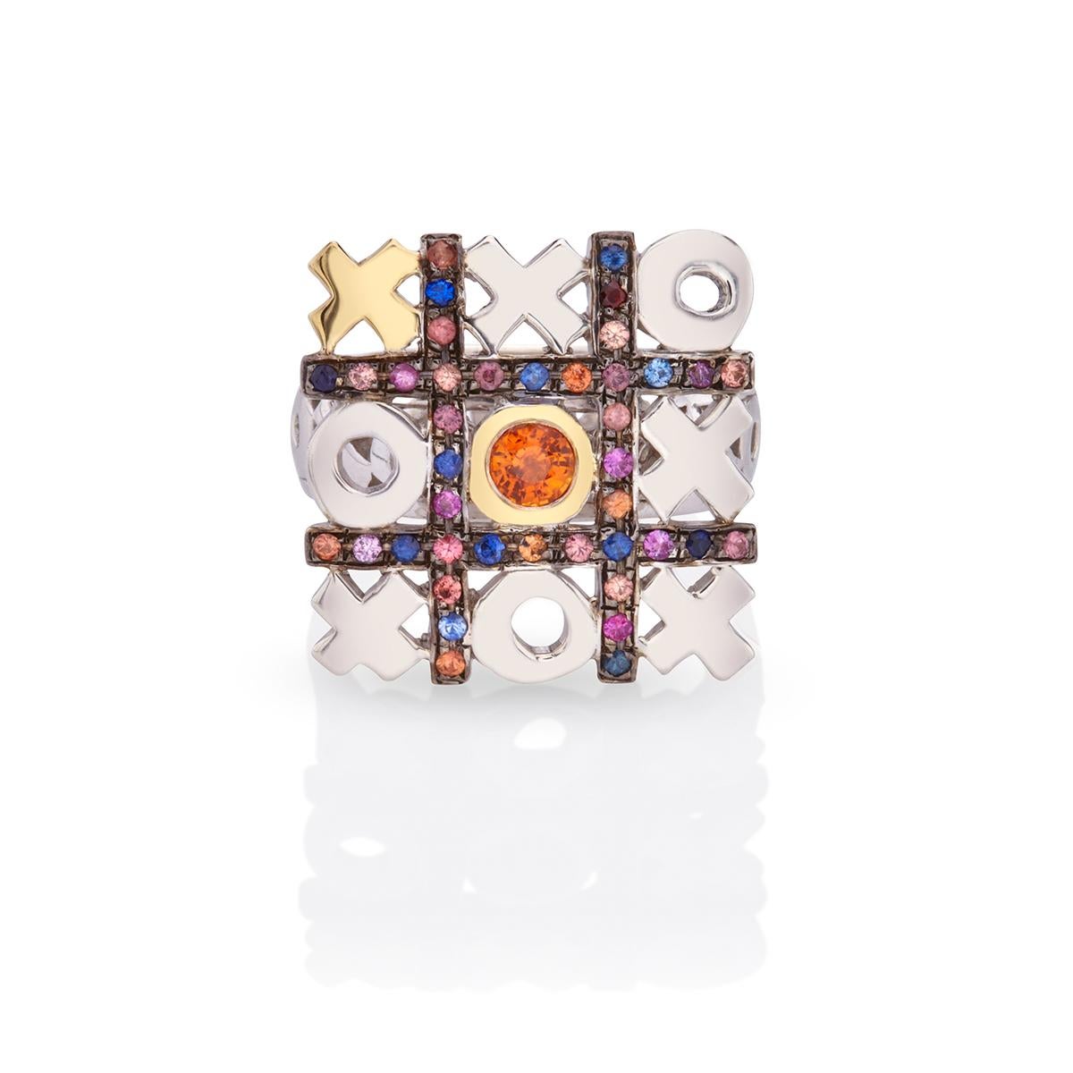 One of a kind Sterling Silver and 18kt Gold multi-colour Sapphire Tic-Tac-Toe Ring by Nicofilimon.
This gorgeous ring is handcrafted out of 925 sterling silver & 18kt yellow gold and features stunning multi-coloured sapphire stones 0,60 ct. This