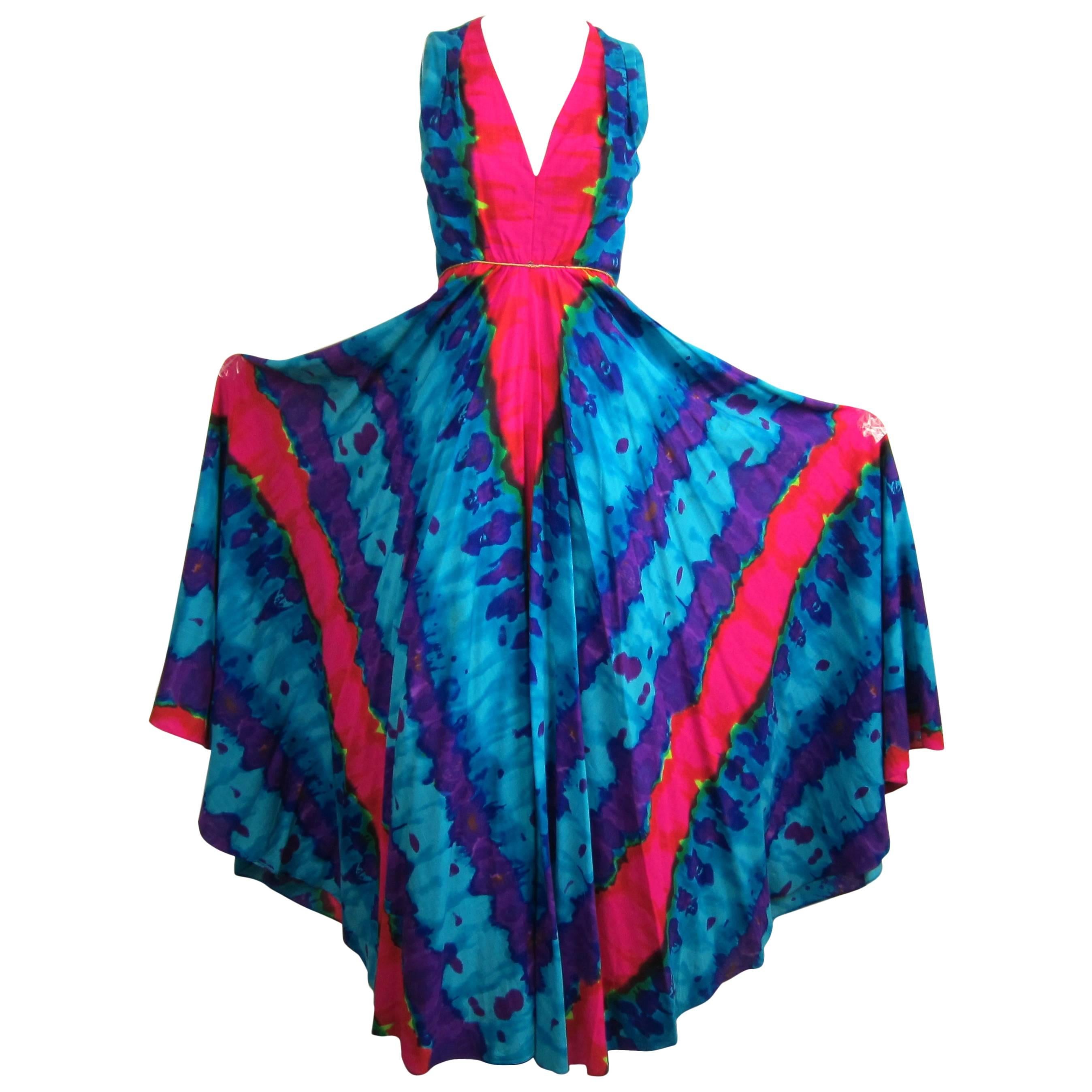 Take a look at this jumpsuit. The legs are on this are crazy! They measure about 60 inches wide. Nice cool colors on this as well. Back zippers..Lined. This is Fully Lined Measures: 14.25 inches  shoulder to waist-- up to a 32 inch BUST-- up to 25