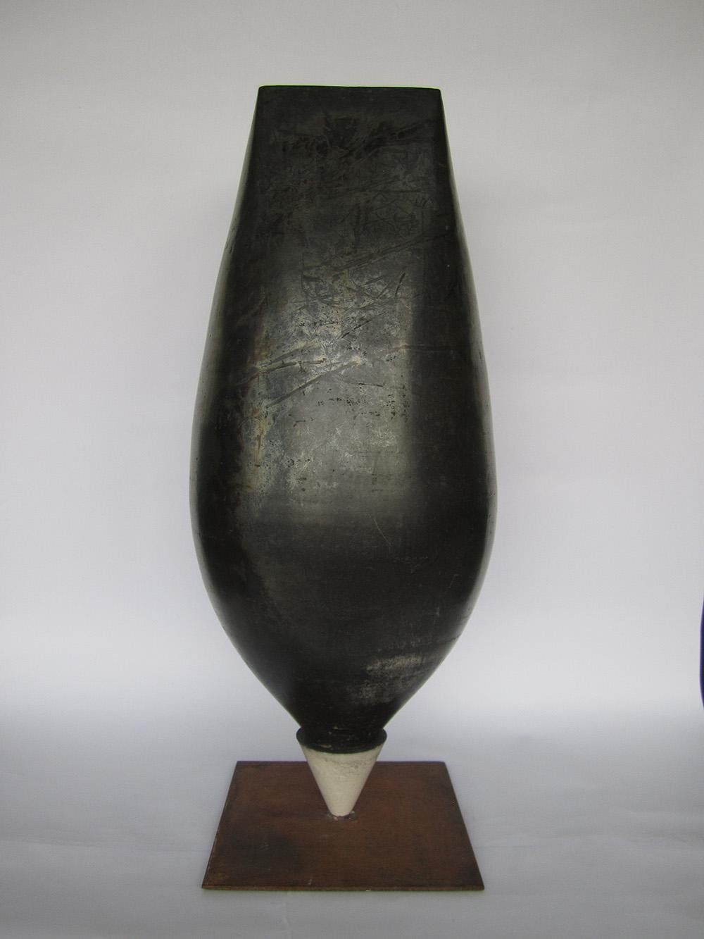 Spinning-top ist eine einzigartige Keramikskulptur des zeitgenössischen Künstlers Tien Wen, dessen Werk um die Idee der Abstraktion und die Reinheit der Formen kreist. 57 cm × 24 cm × 24 cm.
Dank der Raku-Technik, die dem Künstler sehr am Herzen