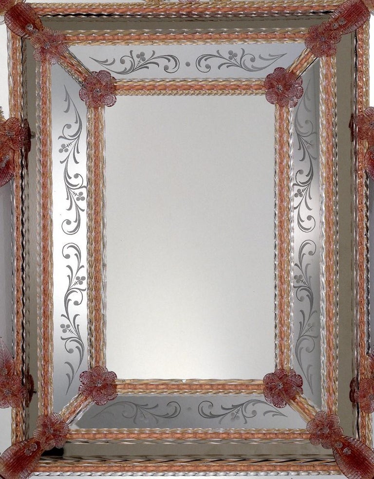 Venetian style mirror made to a design by Fratelli Tosi, in Murano glass, entirely hand made following the techniques of our ancestors. Mirror composed of a central rectangle with crystal and ruby frame in Murano glass and decorated with curls in