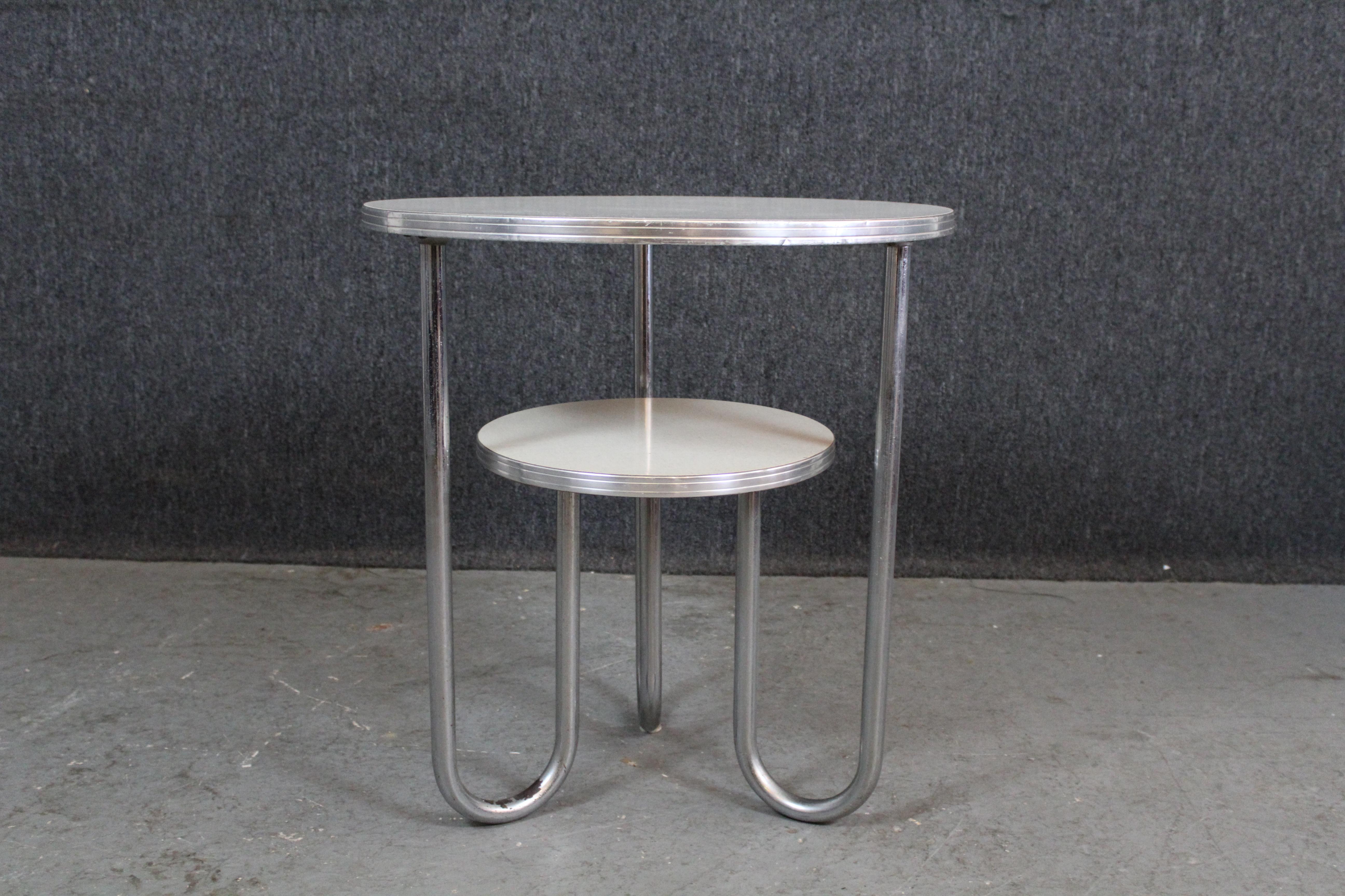 From the Bauhaus to your house, don't miss out on the magic of genuine Art Deco design by Wolfgang Hoffman for America's iconic Royal Chrome Furniture. With a chrome, tubular steel base and two tiered Formica tabletops, this petite yet practical