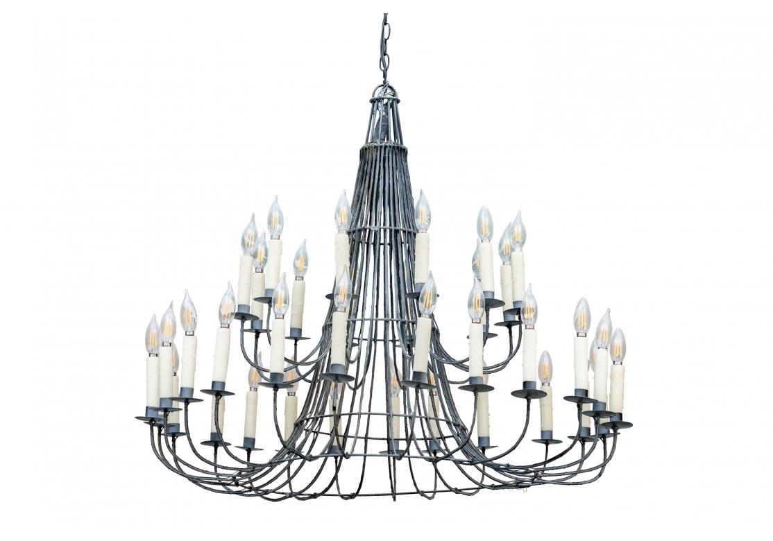 Very well made and visually striking Cone from Wire and iron chandelier with 12 lights over 24 lights with wax candles on tiers of swan-necked iron stems. The fixture has good size balanced nicely with an airy see-through quality. 

Dimensions: 41