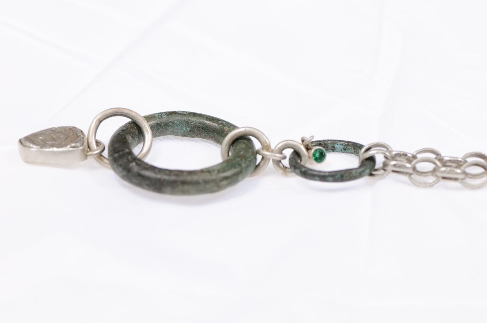 A Celtic proto-currency in bronze with emerald accent and AR Drachm Gorgoneion (coin) on a substantial sterling silver chain. The drachm is from 6th to 4th centuries BC from Thrace of ancient Greece. This coin has been inspected and approved to be