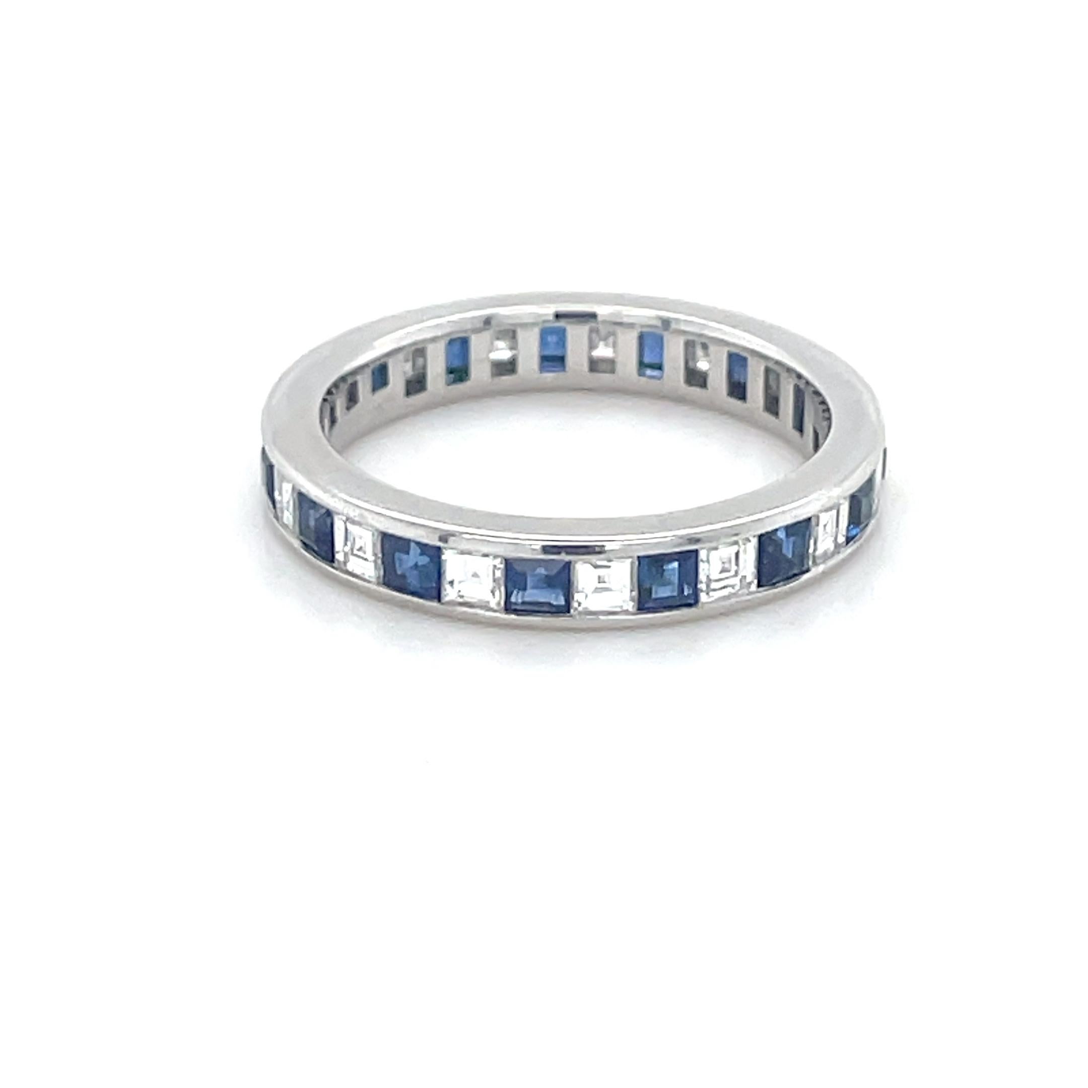 This gorgeous eternity band by Tiffany & Co. features 15 carre cut diamonds weighing approximately 1.50 carats total, intermixed with bright blue carre cut sapphires. Mounted in platinum with top quality craft, this ring is a stunner!

Engraved: