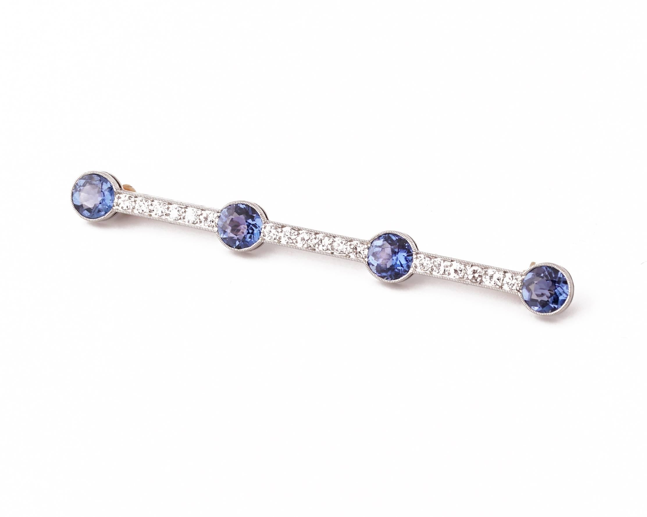 Rare and Beautiful Tiffany & Co Art Deco Brooch, Circa 1925.
Simple elongated millegrained design mounted in platinum, with 3 rows of Round-cut bright diamonds (weight 0.35 carat, F-G colour, VS clarity) and a quartet of bezel-set sapphires (Total