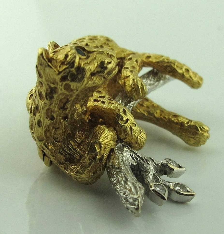 Tiffany & Co. 18 Karat Yellow Gold Cat pin.  12 Grams of gold.  Cat is sitting on an 18 karat white gold branch with three round brilliant diamonds on the leaves.  The cat has two Emeralds for the eyes.