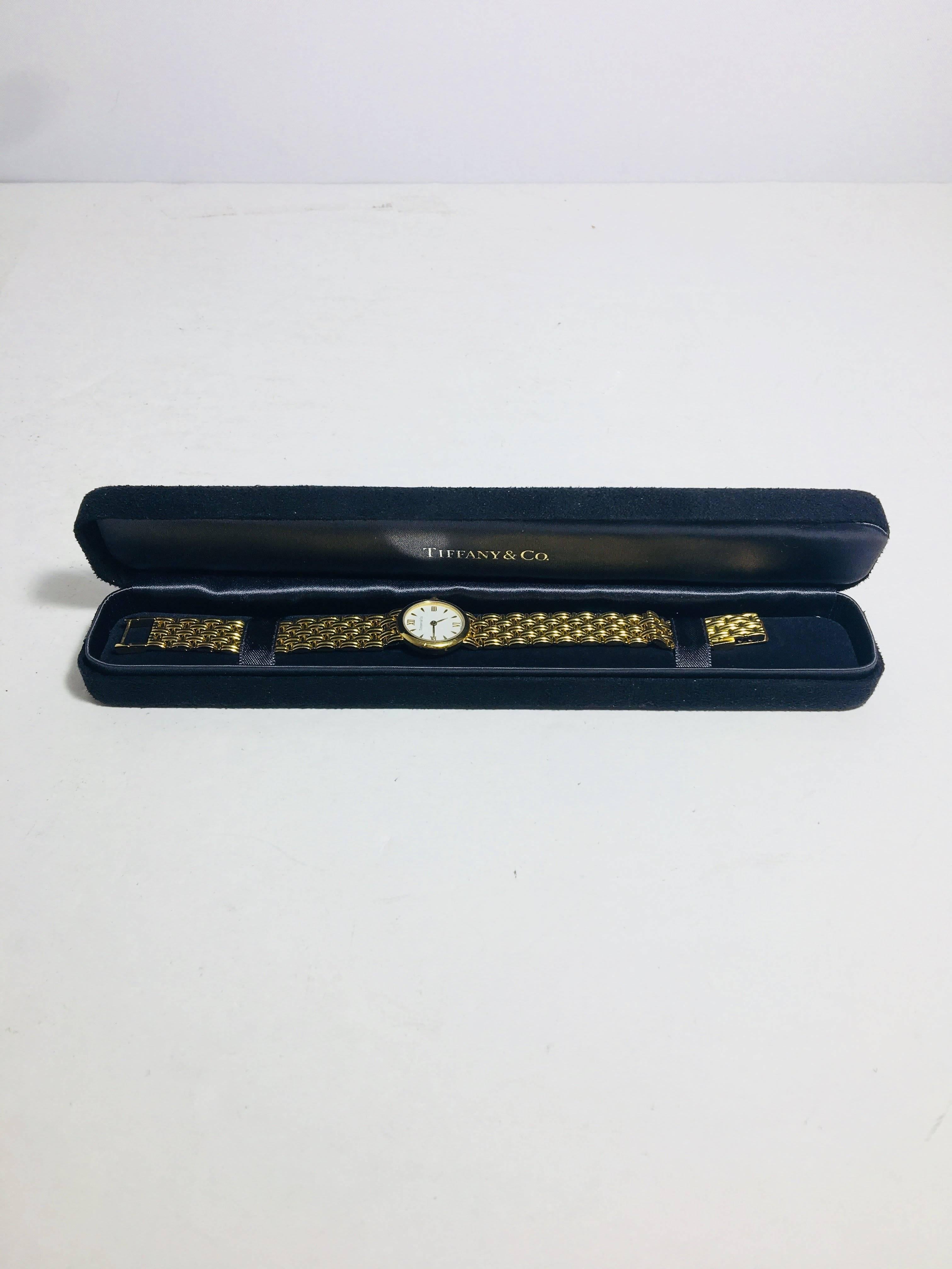 Tiffany & Co. 18k Gold Classic Watch with White Face.
Swiss Made, Water Resistant. With Original Box.