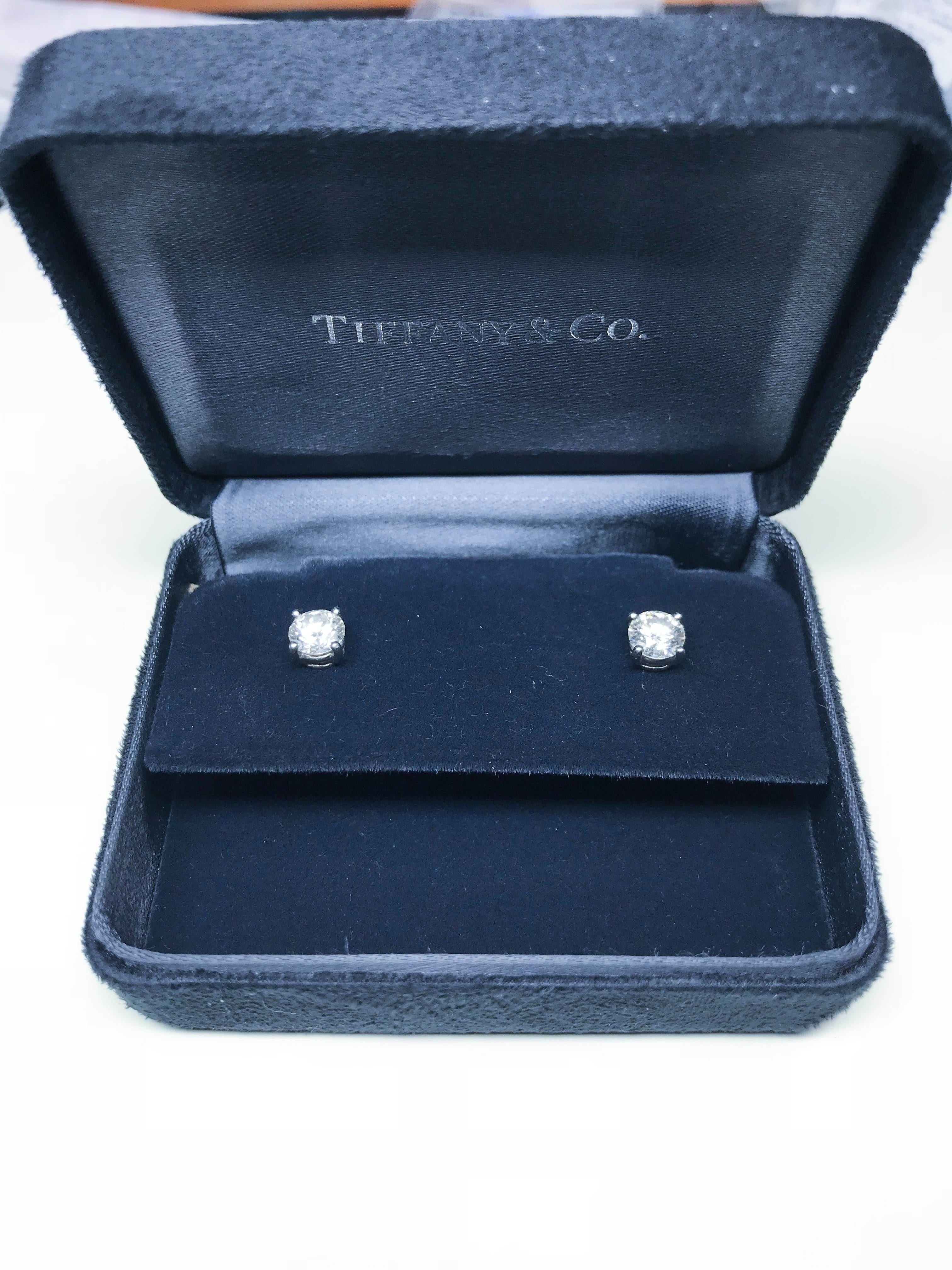 Pair of Platinum Diamond stud earrings from Tiffany & Co.,  with two GIA certified diamonds,  Each diamond weighs exactly .82 Cts,  and each is graded G color , and VS1  clarity.  
Signed 'Tiffany & Co'
Original papers and Box included
Retail