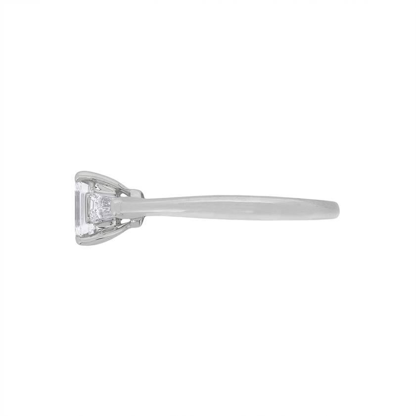 This stunning Tiffany & Co boasts a centre stone of 0.61 carat, which is a beautiful Emerald cut. It has two baguette cuts either side to support it's beauty, totalling 0.20 carat. The side diamonds match the wonderful centre stone in colour and