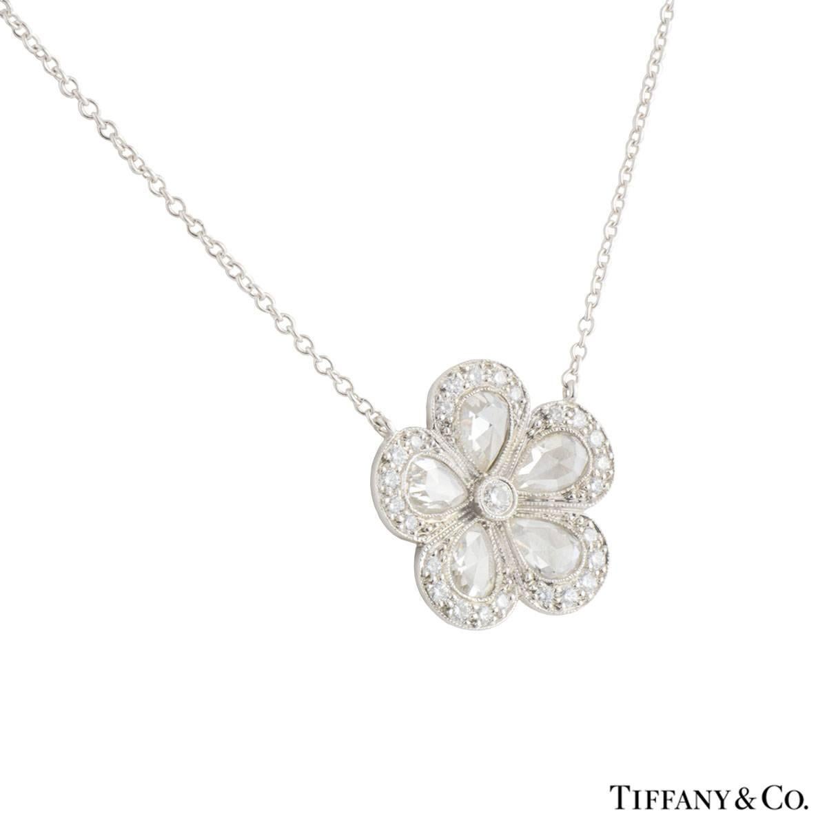 A beautiful platinum diamond Tiffany & Co. pendant from the Garden Flower collection. The necklace comprises of a flower motif with a round brilliant cut as the stigma, 5 rose cut diamonds as the petals with round brilliant cut diamonds detailing