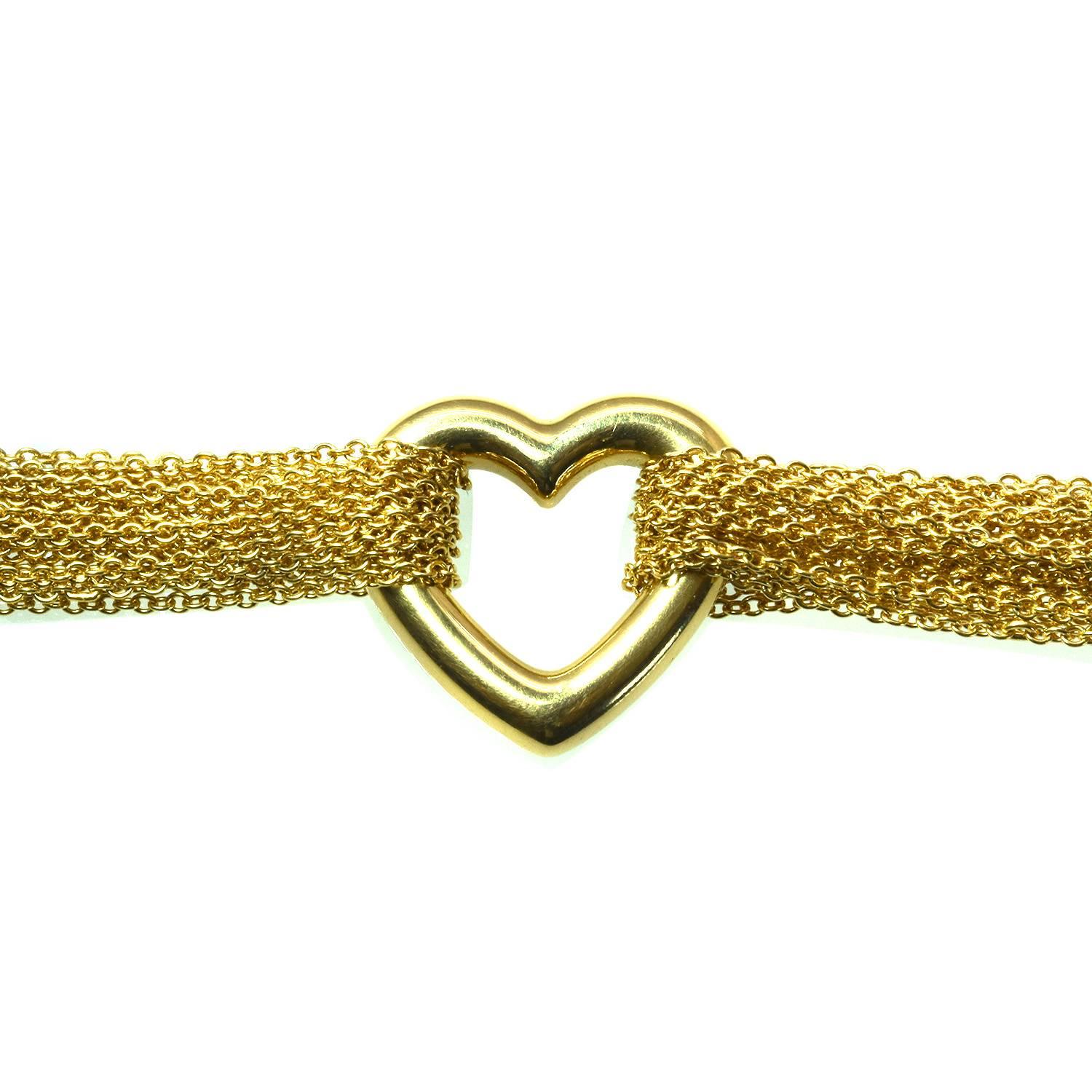 A gold multi-strand bracelet by Tiffany & Co featuring a gold heart center piece and toggle clasp done in 18k yellow gold and signed by Tiffany & Co. 