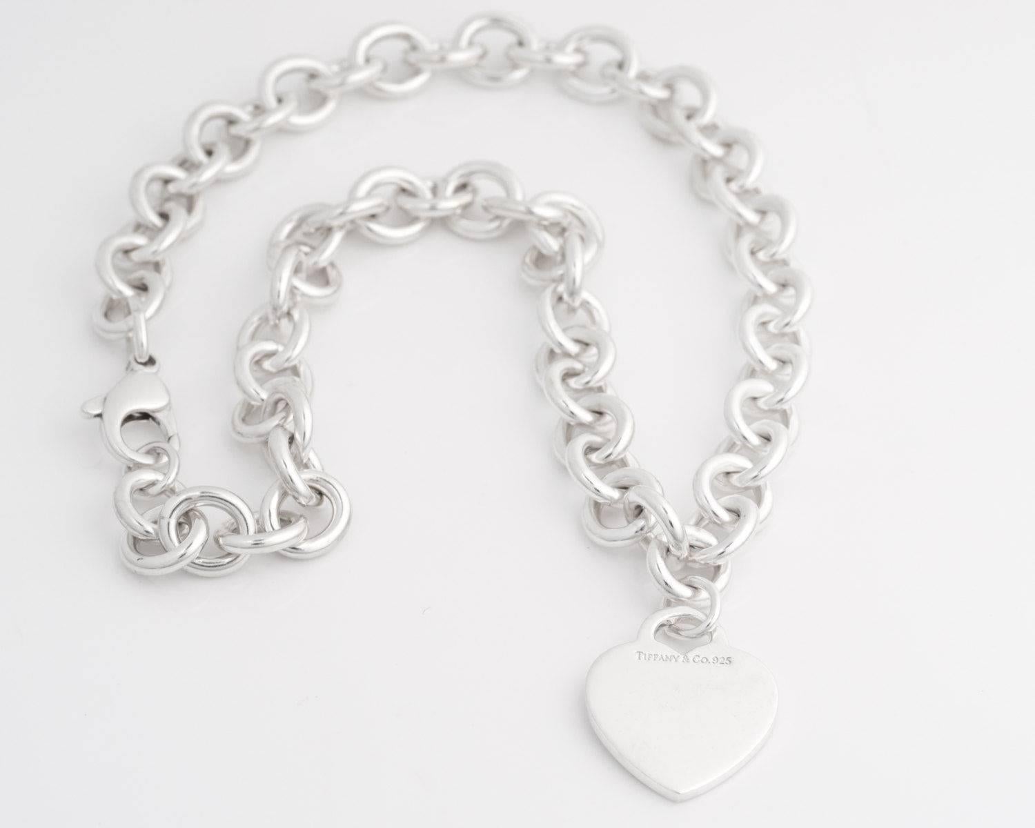 Tiffany and Co. Heart Charm Choker Necklace

This link chain necklace is made from Sterling Silver. It has a heart charm at the center front. This charm may be engraved if you wish. The necklace fastens securely with a lobster claw clasp. 

This